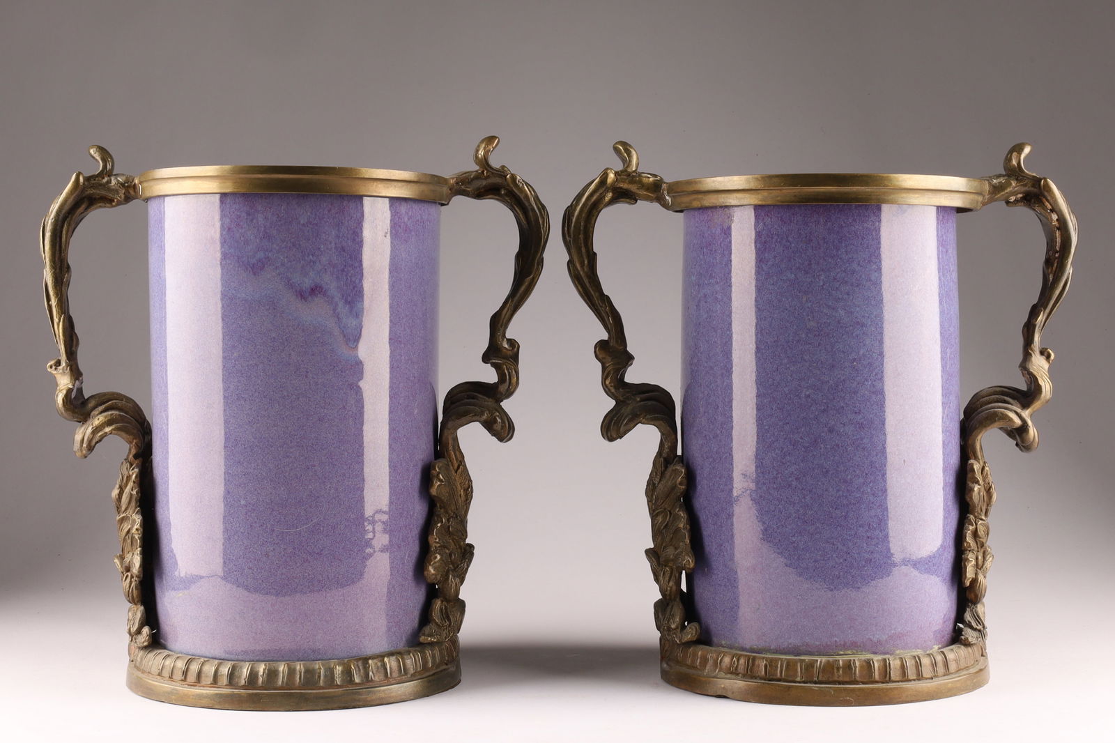 Pair of Nouveau-Style Purple Porcelain Vases with Bronze Mounts: Pair of Nouveau-Style Pale Purple Glaze Porcelain Vases with decorative bronze or ormolu mounts. Measuring 12 inches H x 11 W.