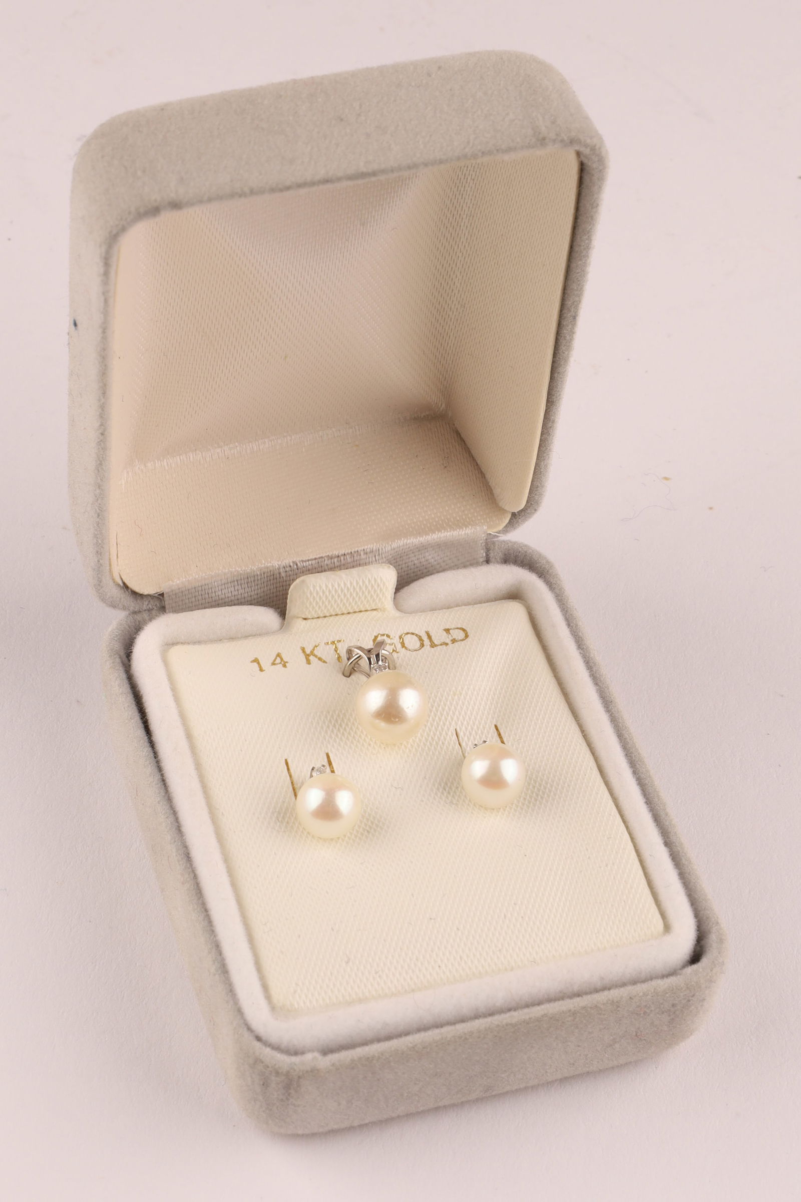 14K White Gold Pearl and Diamonds Earrings and Pendant Set: 14K White Gold Pearl and Diamonds Earrings and Pendant Set. In original box. Earrings measure 5 mm, pendant measures 10 mm. No chain for the pendant.