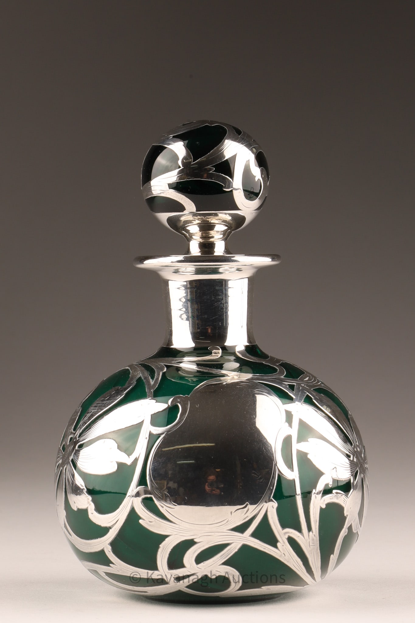 Antique Art Nouveau Green Silver Overlay Glass Perfume Bottle: Antique Art Nouveau perfume bottle featuring a green glass body with an intricate sterling silver overlay. Style: Art Nouveau floral design. Manufacturer: Often attributed to the Gorham Manuf