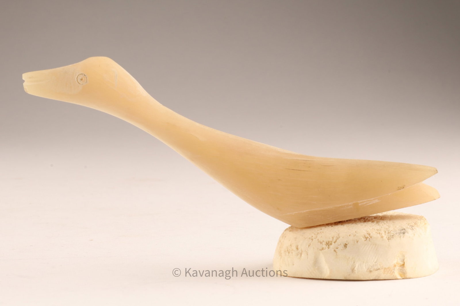 Tegearak Inuit Carved Bird, Cambridge Bay (Ikaluktutiak), CPS 122: Stylized Inuit bird carved with elongated neck and simplified wings, mounted in a rounded bone base. Retains labels identifying the artist Tegearak of Cambridge Bay (Ikaluktutiak), Nunavut, with inven