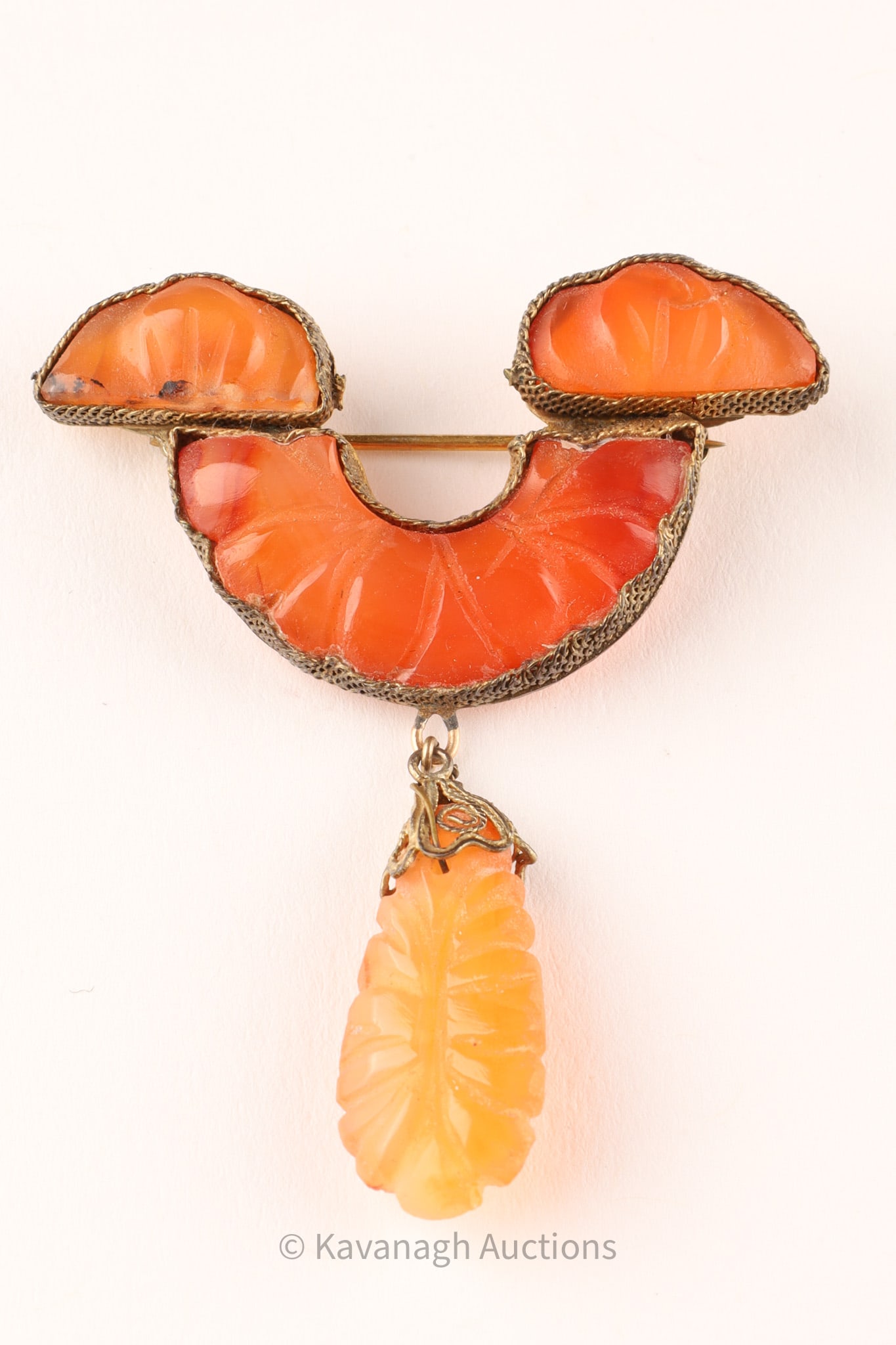 Chinese Carved Carnelian Brooch with Pendant Drop: Chinese Carved Carnelian Brooch with Pendant Drop arranged in a stylized three-part form with a suspended leaf-shaped pendant drop. The stones are carved with radiating and foliate motifs and set