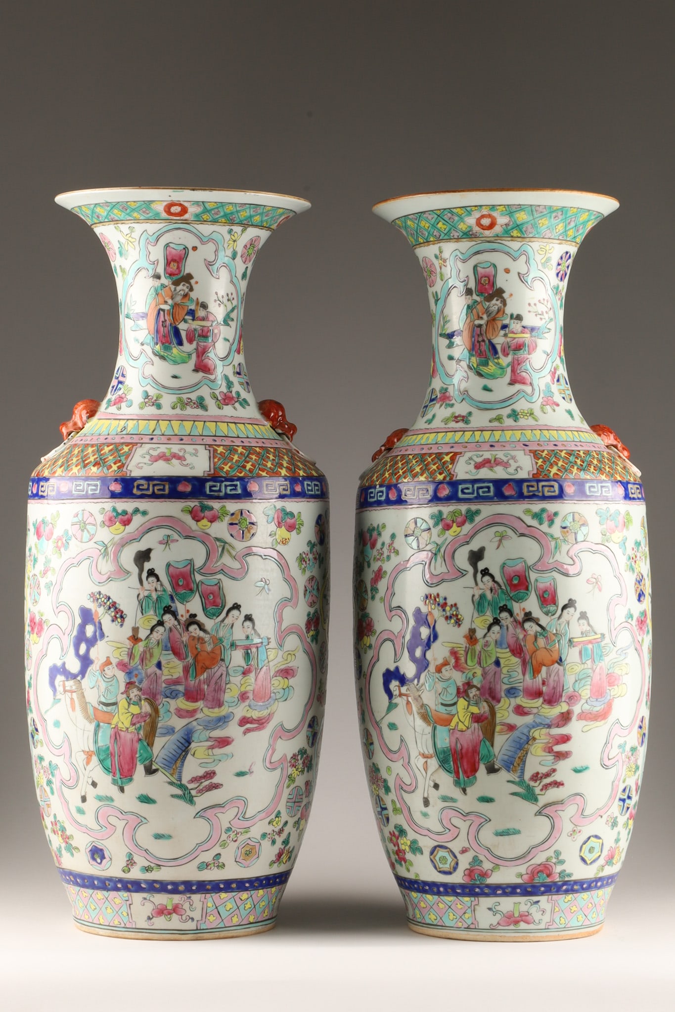 Pair of Signed Chinese Famille Rose Porcelain Vases: A pair of Chinese Famille Rose porcelain vases decorated with colourful depictions of figural court scenes and auspicious symbols. Style: Famille Rose polychrome enamel decoration featuring