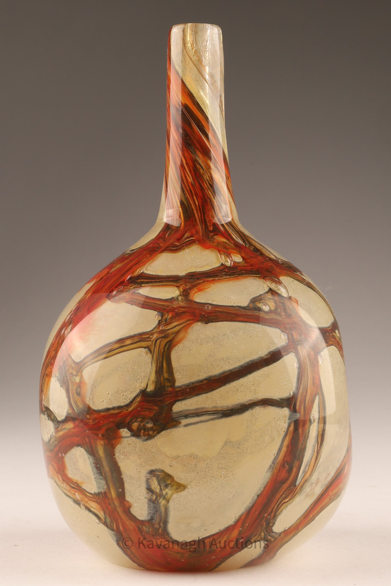 Mdina Glass Bottle Vase, Sand and Trailed Decoration, Malta: Mdina art glass bottle vase of rounded form with a slender cylindrical neck, decorated with applied trailing in tones of amber, brown, and olive over a sandy-textured ground. The composition is encase