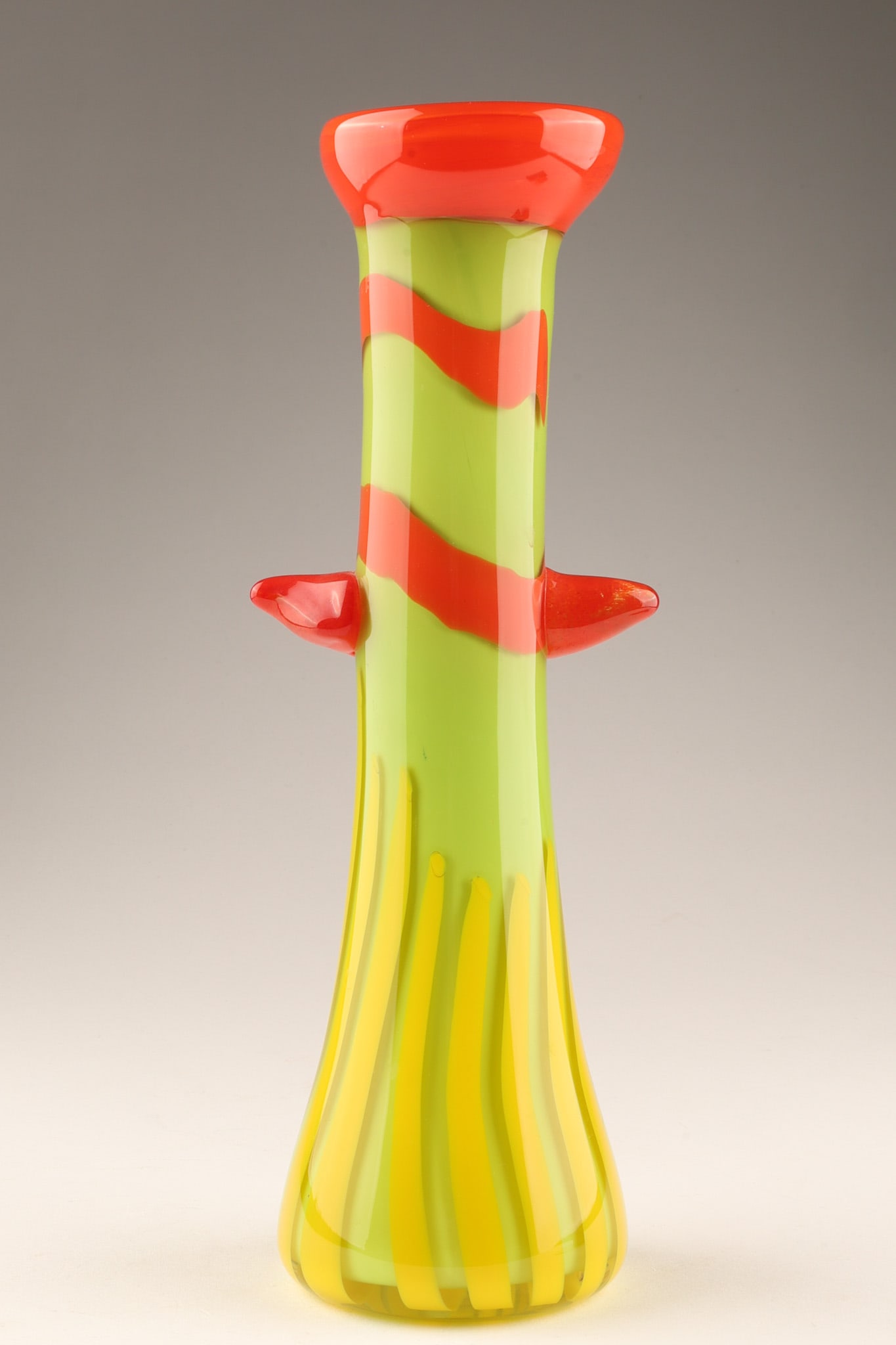 Bruno Andrus Canadian Art Glass Whimsical Vase: A pop art whimsical stripped art glass vase by Bruno Andrus, a distinguished Canadian glass artist and art historian based in Montreal. It features a vibrant, playful aesthetic with a green body