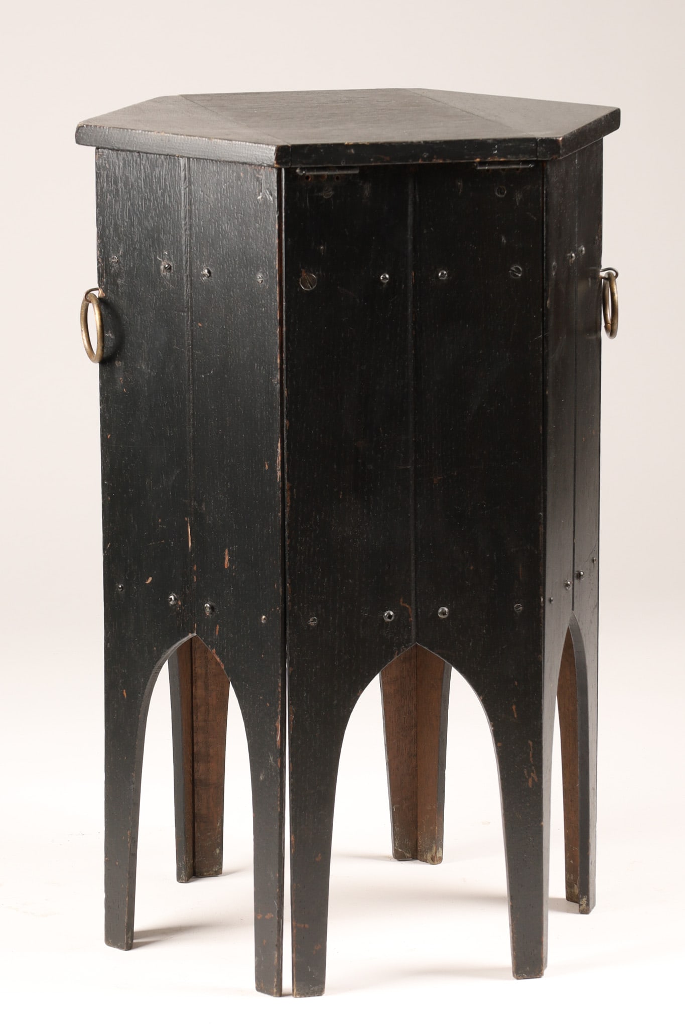Arts and Crafts or Gothic-Revival sewing table c. 1900: Arts and Crafts or Gothic-Revival sewing table (c. 1900) finished in a striking black with hinged lift-top hexagonal lid which opens to reveal a deep, interior designed to hold fabric, yarn, or sewing
