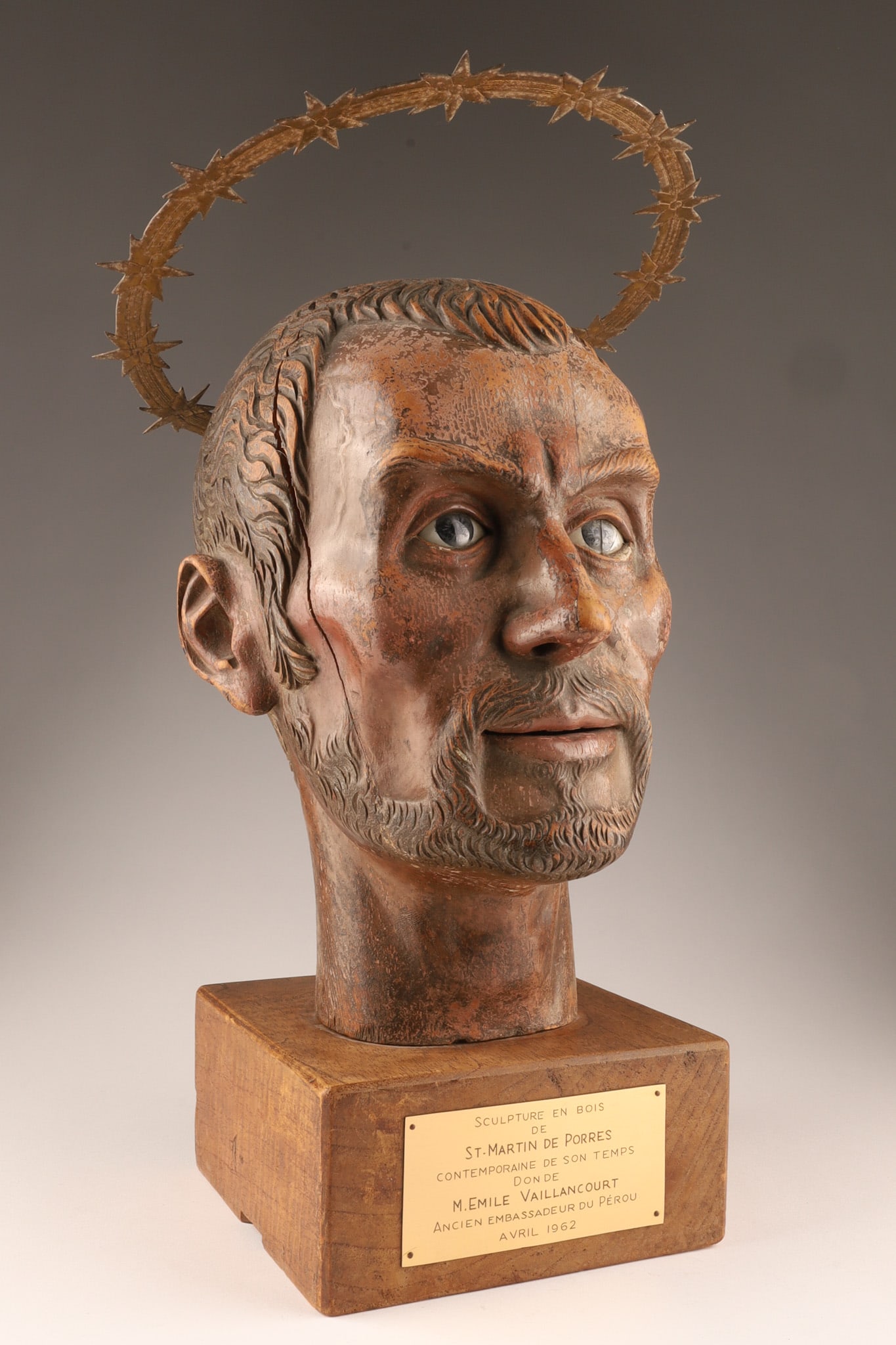 Early 17th C. St-Martin De Porres Wood Caved Head with Glass Eyes and Gilt Barbed Halo: St. Martin de Porres, a Peruvian Dominican lay brother known for his service to the poor and abandoned. Wood carved bust with fine features and glass painted eyes with a distinctive metal halo of thor