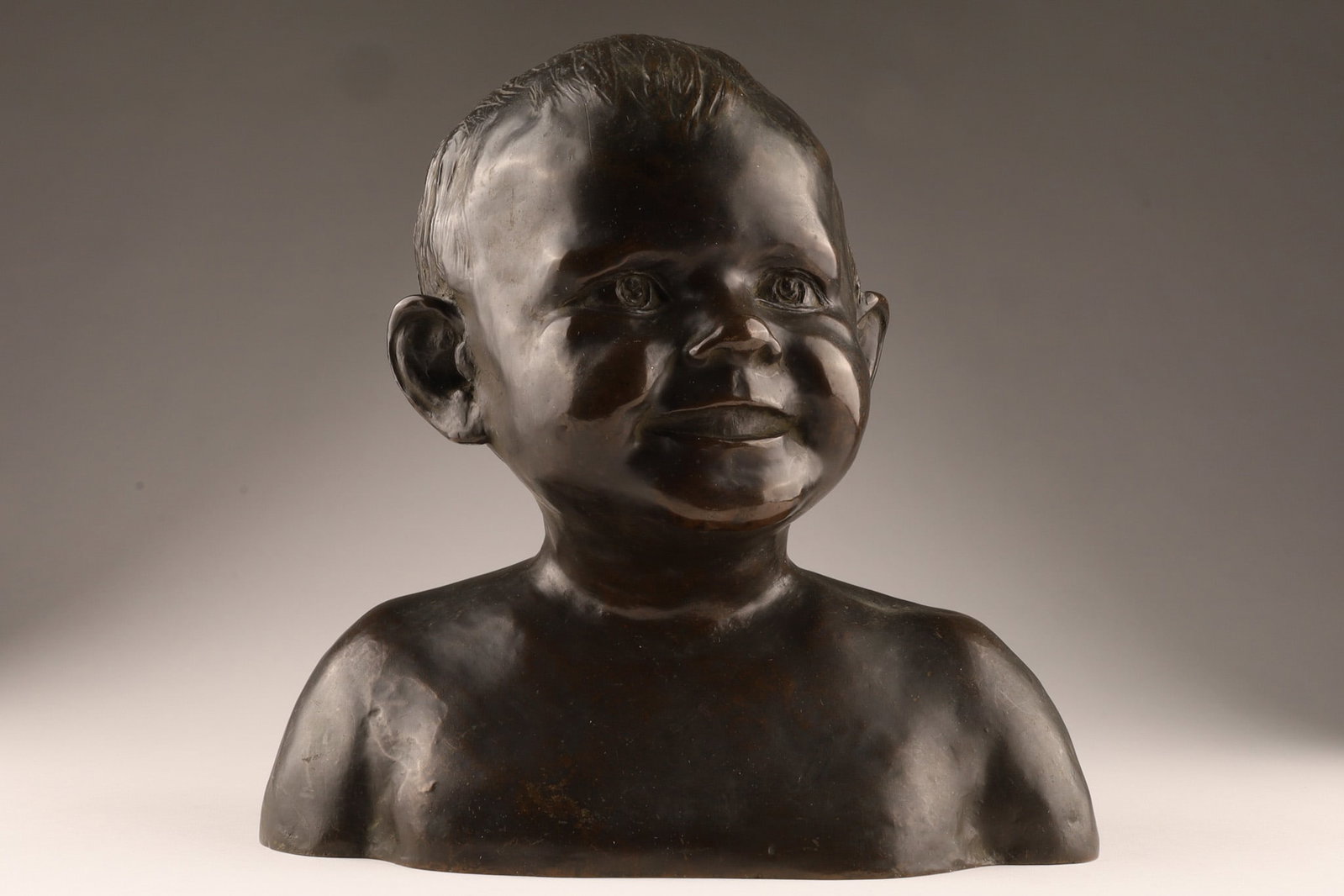Enzo Serafini (Italian-American) 1920s Child Bust Bronze American Art Foundry NY: A 1920s child bust bronze by Italian-American sculptor Enzo Serafini, cast by the American Art Foundry in New York, represents a characteristic example of early 20th-century American figural sculpture