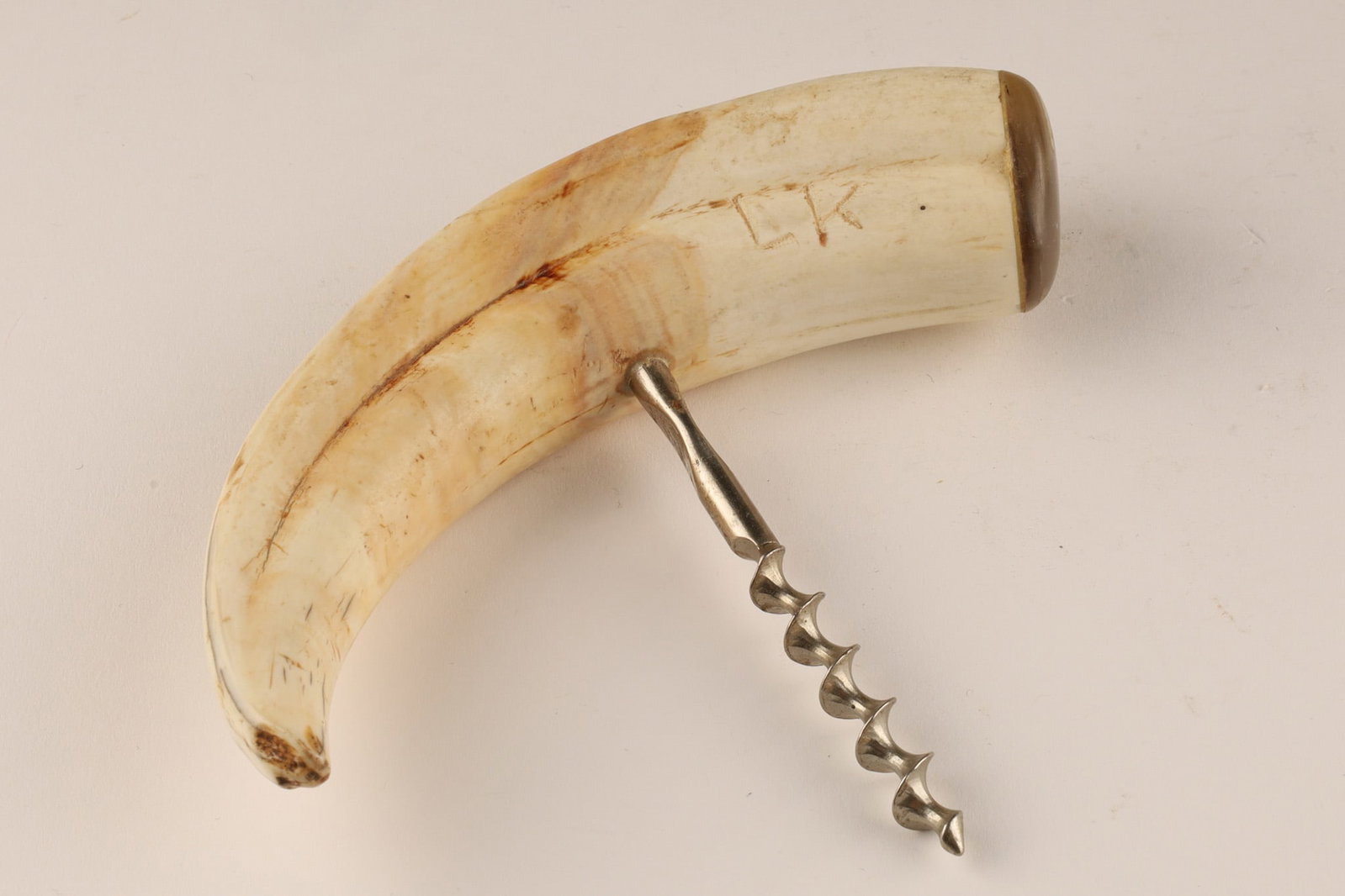 Antique Boar's Tusk Barware Corkscrew C. 19th-20th C: Antique boar's tusk barware corkscrew, circa 19th or early 20th century, which features a natural tusk handle and metal mounts. Material: The handle is crafted from a genuine boar tusk. Mo