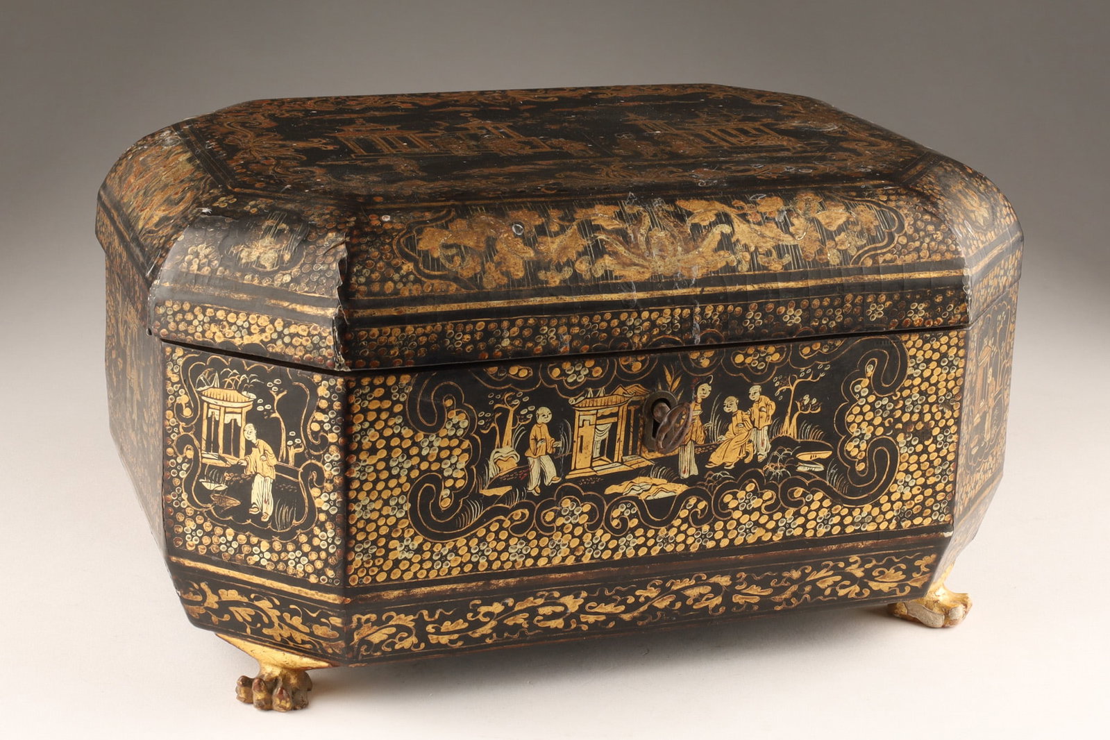 19th C Chinese Export Black Lacquer Tea Caddy with Pewter Inserts: 19th-century Chinese export black lacquer tea caddy with paktong or pewter inserts. It features an octagonal form decorated with intricate gilt chinoserie landscapes, pavilions, and figures. The piece