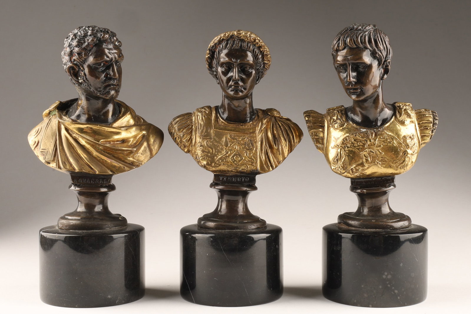 Collection Grand Tour Bronze Busts of Roman Emperors: Collection of antique Grand Tour solid bronze busts of Roman Emperors - Caesar Augustus, Tiberius and Caracalla, polished and patinated elements, and set on polished round grey marble bases, the names