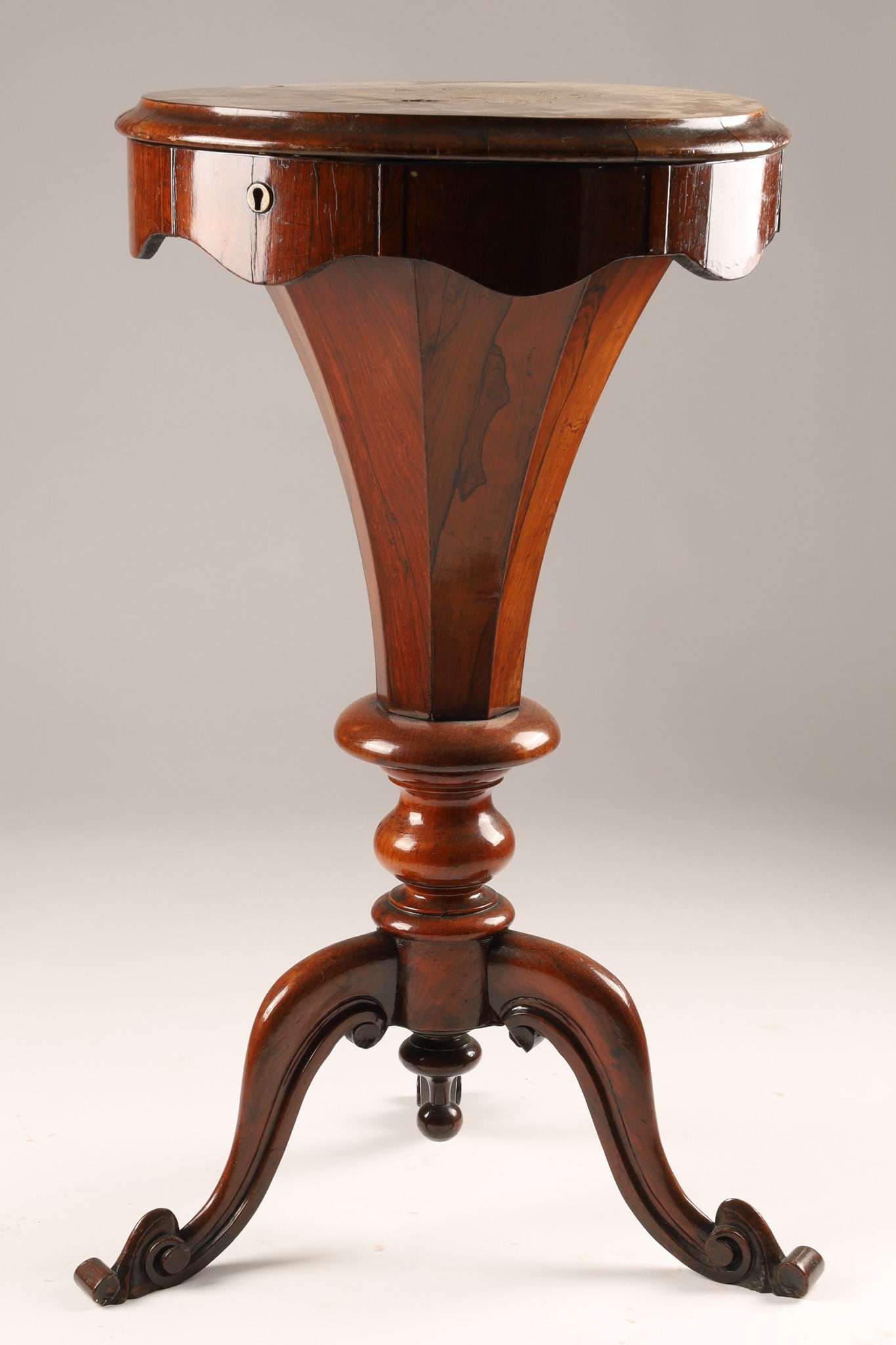 Antique Victorian Trumpet Sewing Table With Marquetry Flowers: A Victorian-era trumpet sewing or work table, the lid features delicate marquetry depicting floral medallions, the top lifts to reveal a fitted interior with smaller peripheral compartments for needle