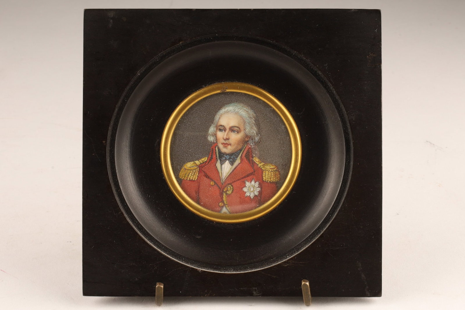 19th C Miniature Portrait Painting of an Officer, Sir Hamilton Signed Armor: A miniature portrait, likely painted in the late 18th or early 19th century, depicting an officer in a red military uniform with gold epaulets and a white star insignia. Signed over sitter's right sho