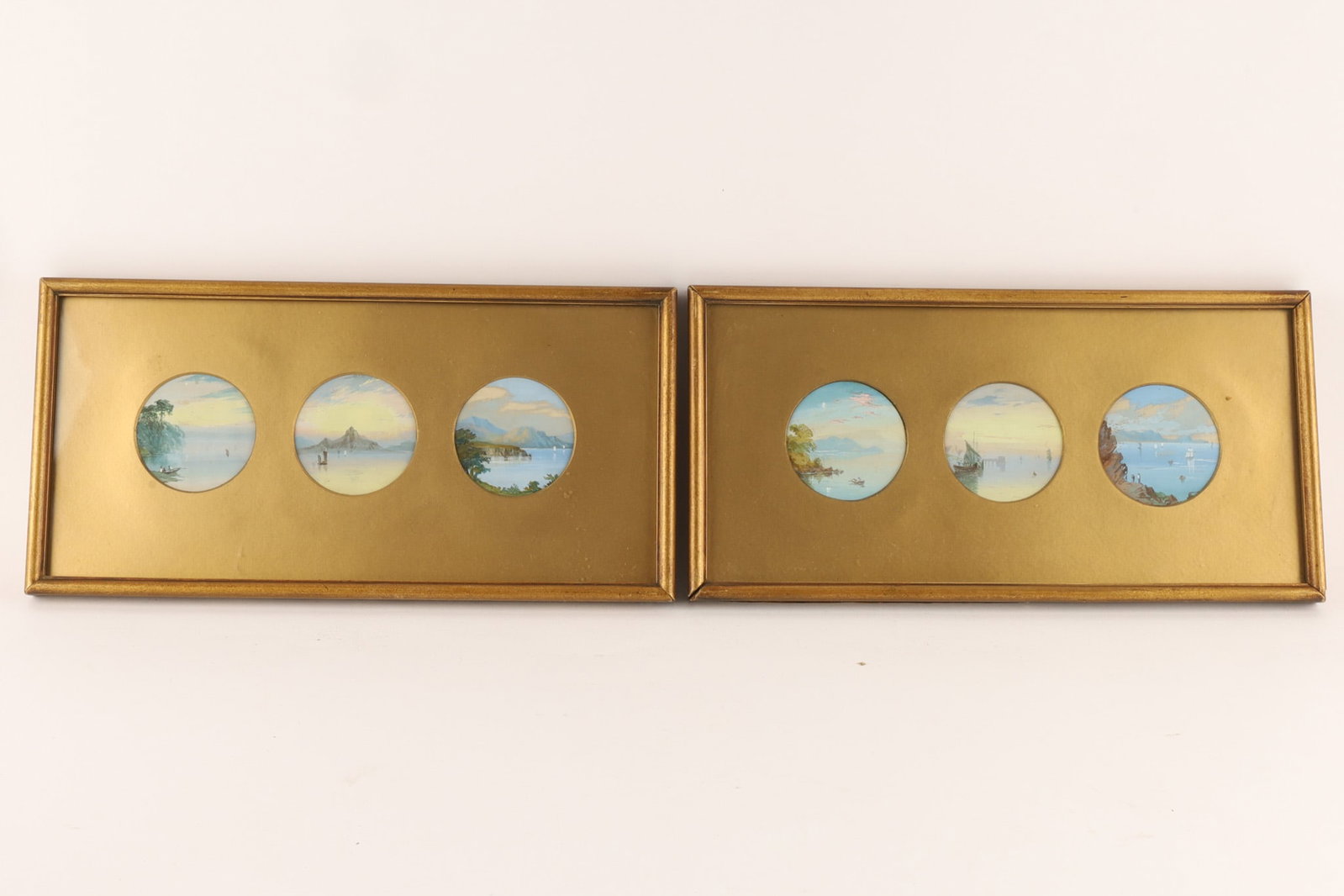 Set of Two Triptych Miniature Watercolour Coastal Landscapes on Silk: Set of Two Triptych Miniature Watercolour Coastal Landscapes on Silk with Mountains in the backgrounds. Housed in in gilded gold circular frames. Inscribed on reverse, Old miniatures on silk painted o