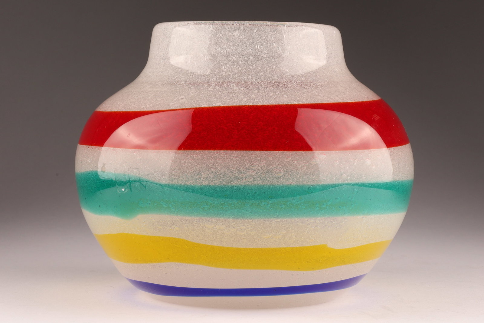 CENEDESE FULVIO BIANCONI Murano Banded Art Glass Vase: Designed by Fulvio Bianconi for Cenedese circa 1980, this small vase features vibrant horizontal stripes in bold colours on a bubble glass ground, signed on underside. Measuring 6 inches H x 7 W. From