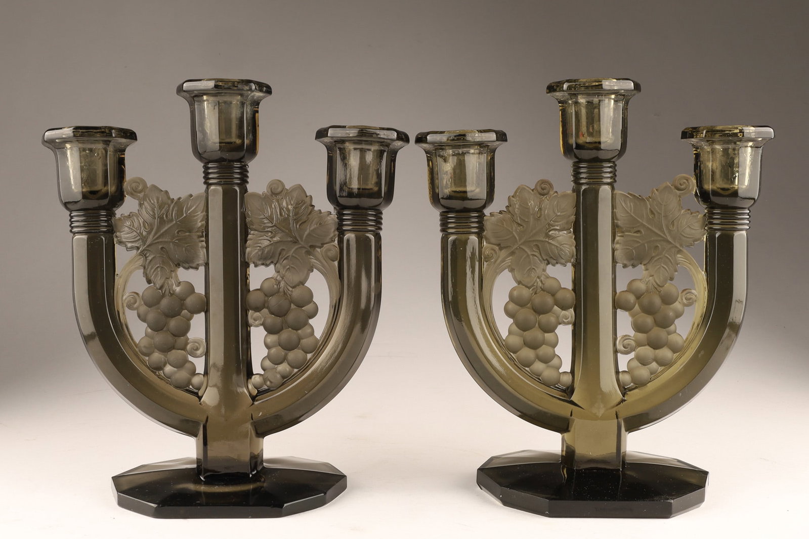Pair Joseph Inwald Barolac Czech Art Glass Grape Design Candlesticks: A pair of Art Deco Joseph Inwald Barolac Czech Art Glass Grape Design Candlesticks. Triple-arm (candelabrum) style featuring a molded, high-relief grape and leaf motif with a combination of clear and 