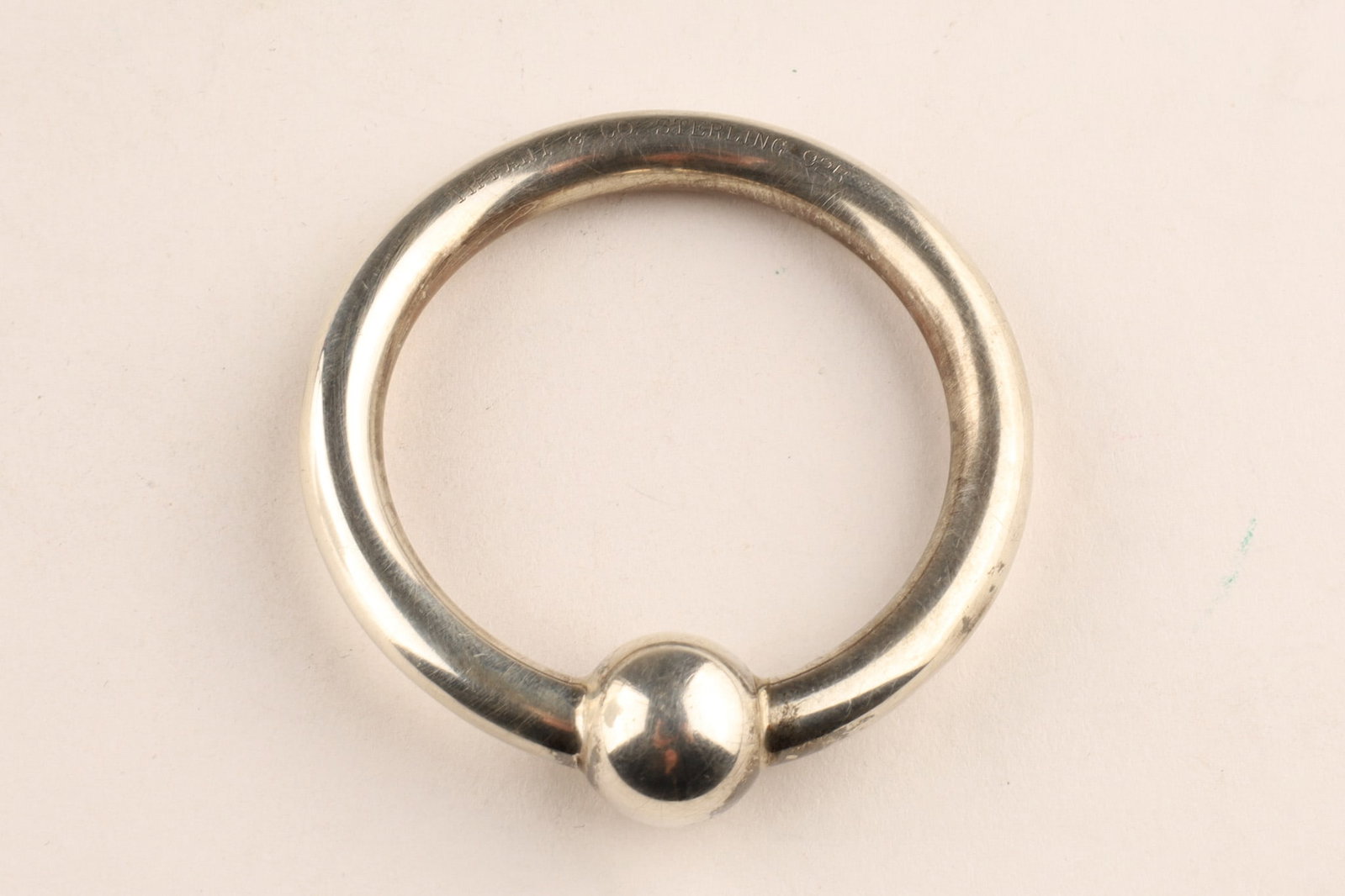 Tiffany and Co. Sterling Silver Baby Teething Rattle: Tiffany and Co. Sterling Silver Circular Baby Teething Rattle, Stamped Tiffany and Co. and sterling silver hallmarks on the inner rim. 14.5 grams, 2.25 inches W.