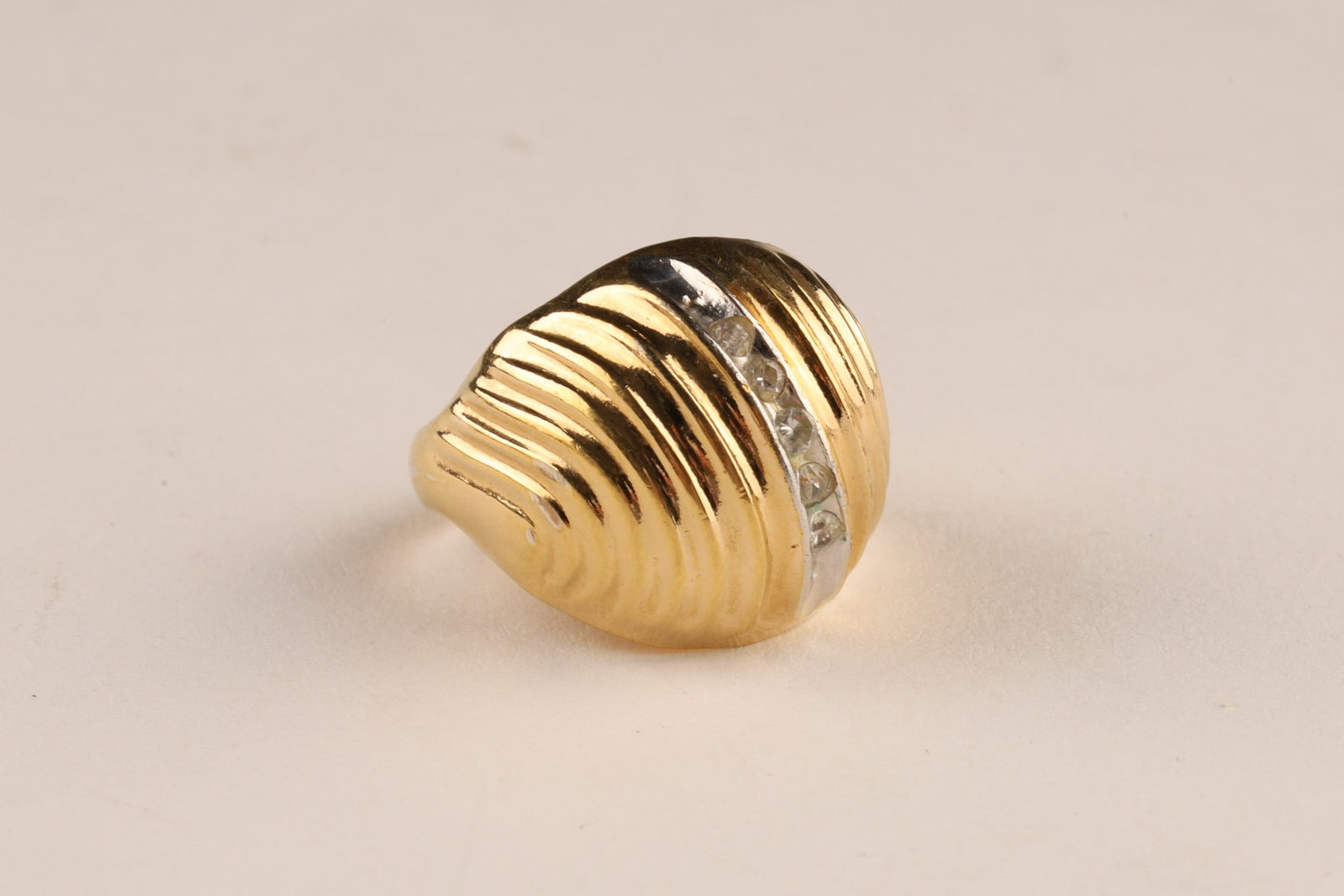 14K Yellow Gold Fluted Dome Ring with Round Diamonds, Size 6: 14K yellow gold dome ring featuring a fluted, ribbed design with a central white gold band set with small round diamonds. 4.6 grams total weight, size 6.