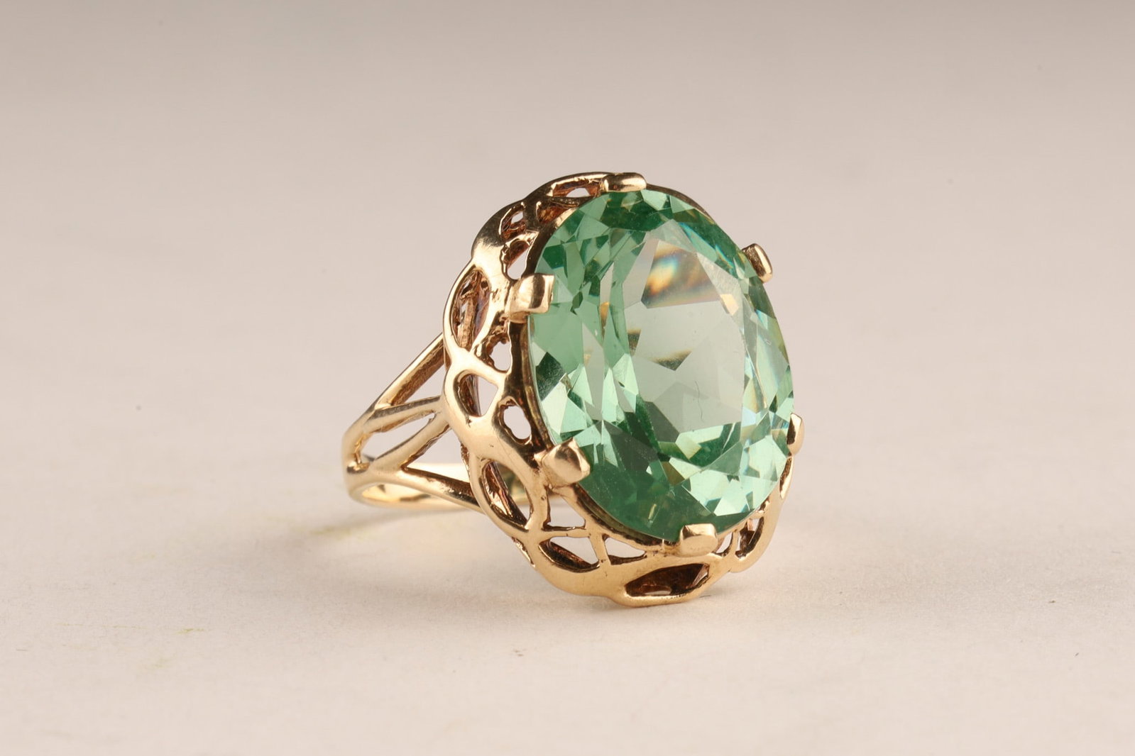 14K Gold and Faceted Sea Green Spinel Cocktail Ring, Size 6: 14K Gold and Faceted Sea Green Spinel Cocktail Ring featuring yellow gold openwork or filigree gallery setting holding a large faceted spinel in prongs, measuring 16 mm x 12 mm. Total weight 5.2 grams