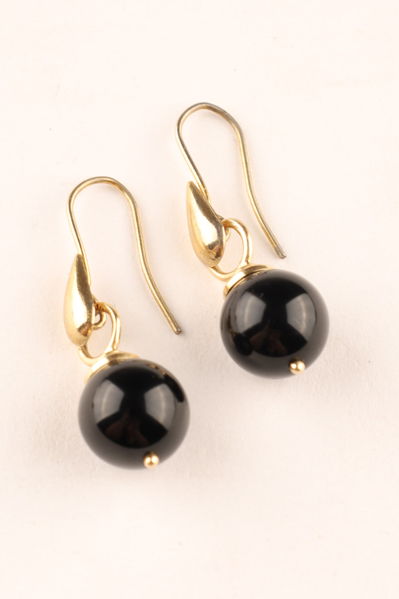 Regency 14K Gold Black Obsidian Mourning Earrings: Pair of Regency period mourning earrings made of 14K gold set with black obsidian balls, simple design and color as a statement of being in mourning, circa first half 19th century, various marks on ro