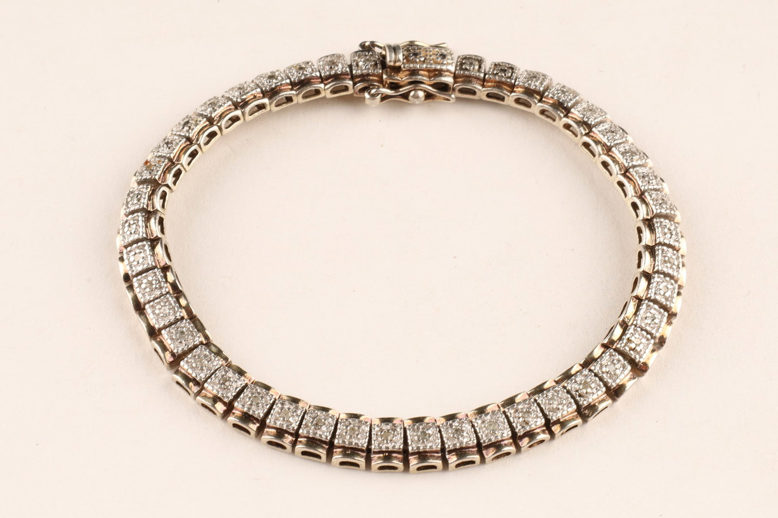 Sterling Silver and Diamond Accent Articulated Tennis Bracelet: Classic structured tennis bracelet featuring miracle-plate illusion set diamond-accented rectangular links with secure integrated box clasp with dual safety latches. 7.75 inches L, 19.3 grams total.