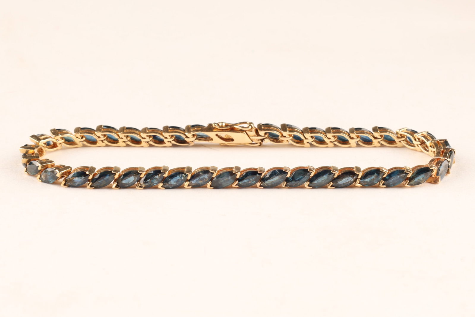 Vintage 14K Gold and Dark Blue Topaz Tennis Bracelet: Vintage 14K Gold and Dark Blue Marquise Cut Topaz Tennis Bracelet. Marked on clasp. 8 inches L, 12 grams total weight.