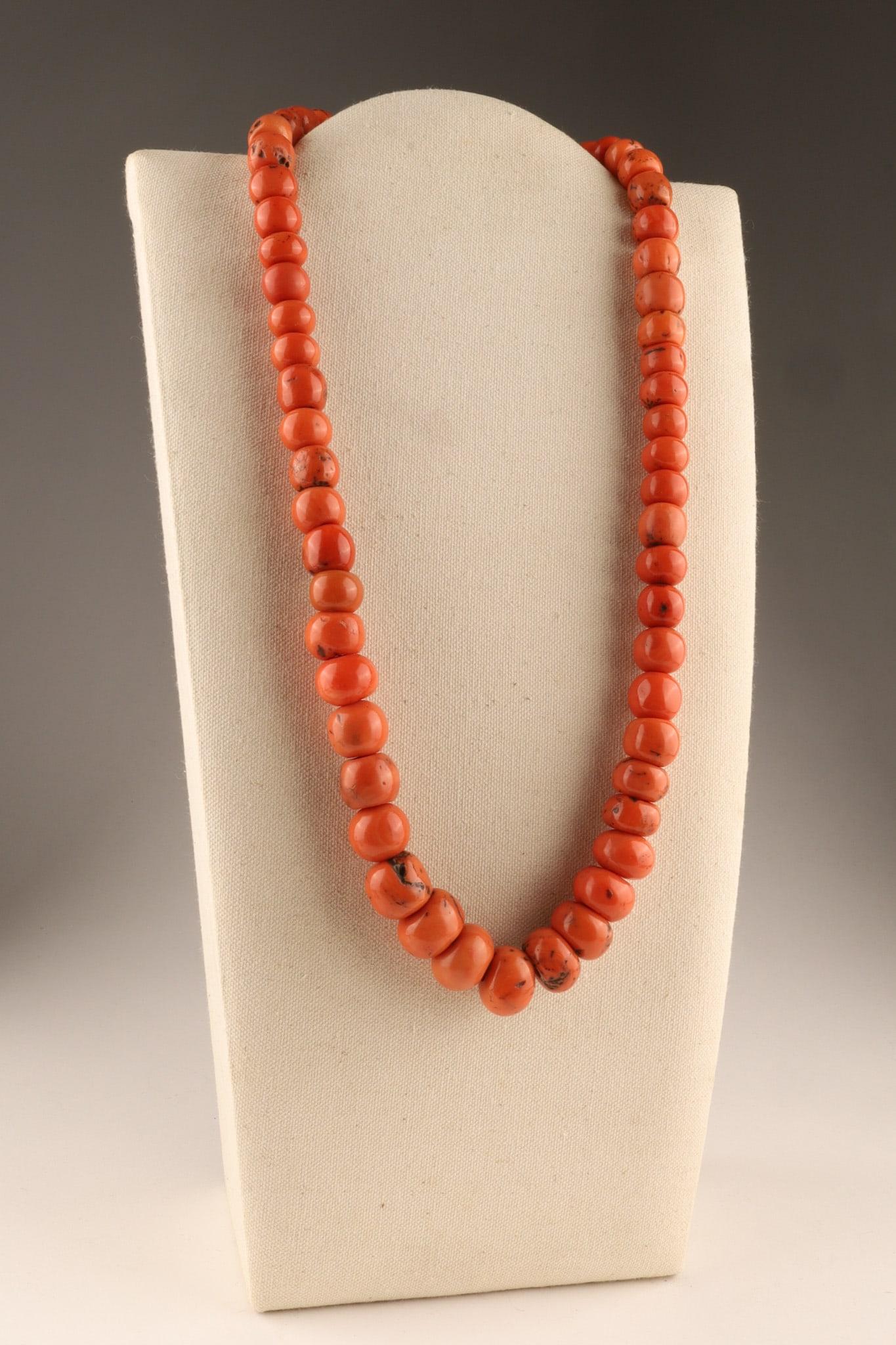 Antique Tibetan Coral Graduated Beads Necklace: Antique Tibetan Coral Graduated Beads Necklace featuring graduated, polished beads of a deep coral colour with black inclusions. Largest beads measure 21 mm, smallest beads measure 12 mm, 336.5 grams,