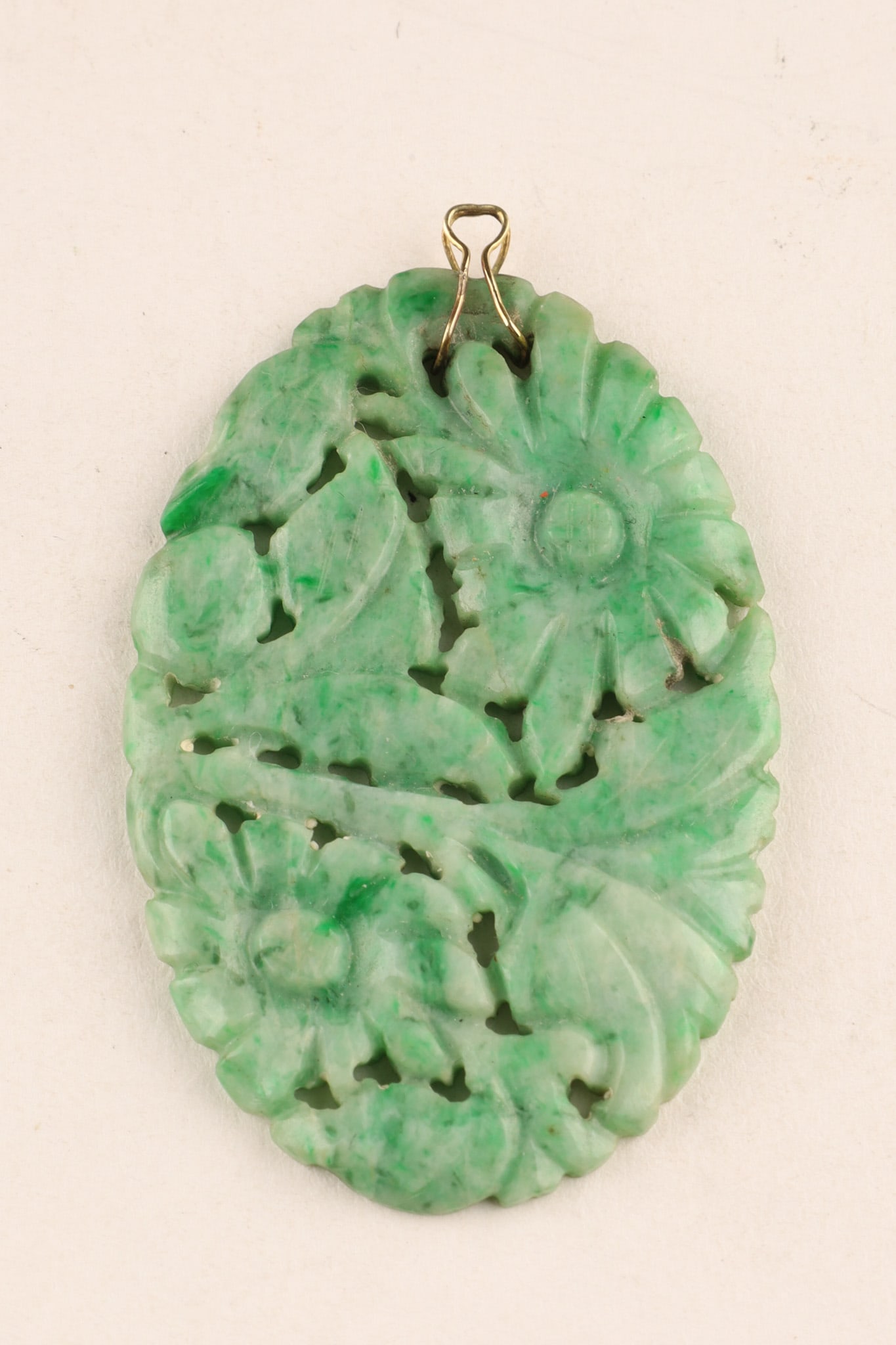 Chinese Natural Green Jade Carved Floral Pendant: Antique Chinese natural green jade carved pierce work floral pendant with gold wire bail. 1.75 inches H.