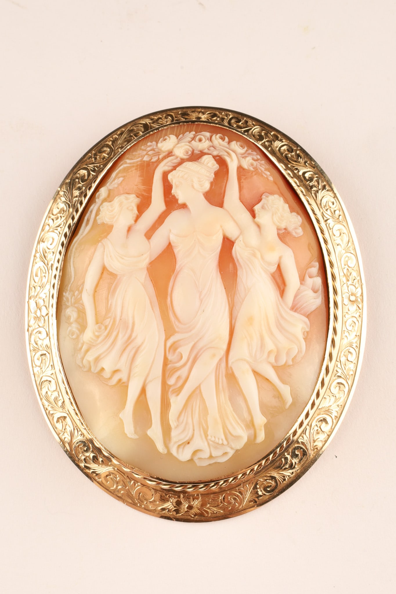 Very Large 14k Gold Carved Three Graces Cameo Brooch/Pendant: An unusually large antique hand-carved shell cameo brooch depicting The Three Graces set in a finely worked 14K gold frame. Marked 14K Dimensions: Total weight 40.8 grams, 3 inches H x 2.5 W.