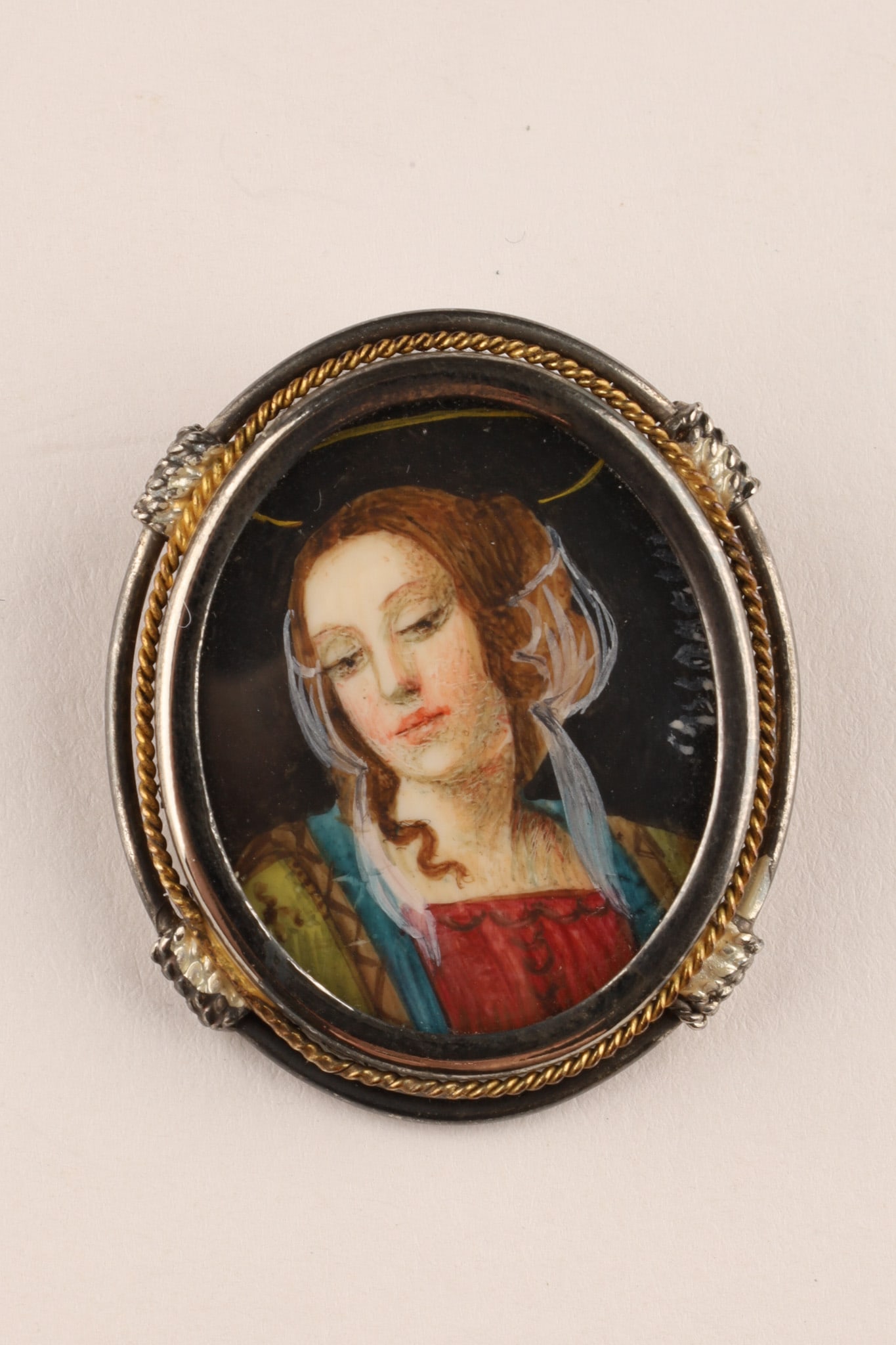 Antique Sterling Renaissance Style Miniature Portrait Brooch of a Lady Signed: Antique brooch featuring a hand-painted portrait miniature of A Lady / the Madonna set within a sterling silver filigree frame, signed over the right shoulder. Dimensions: 31.5 x 27mm 6.6 