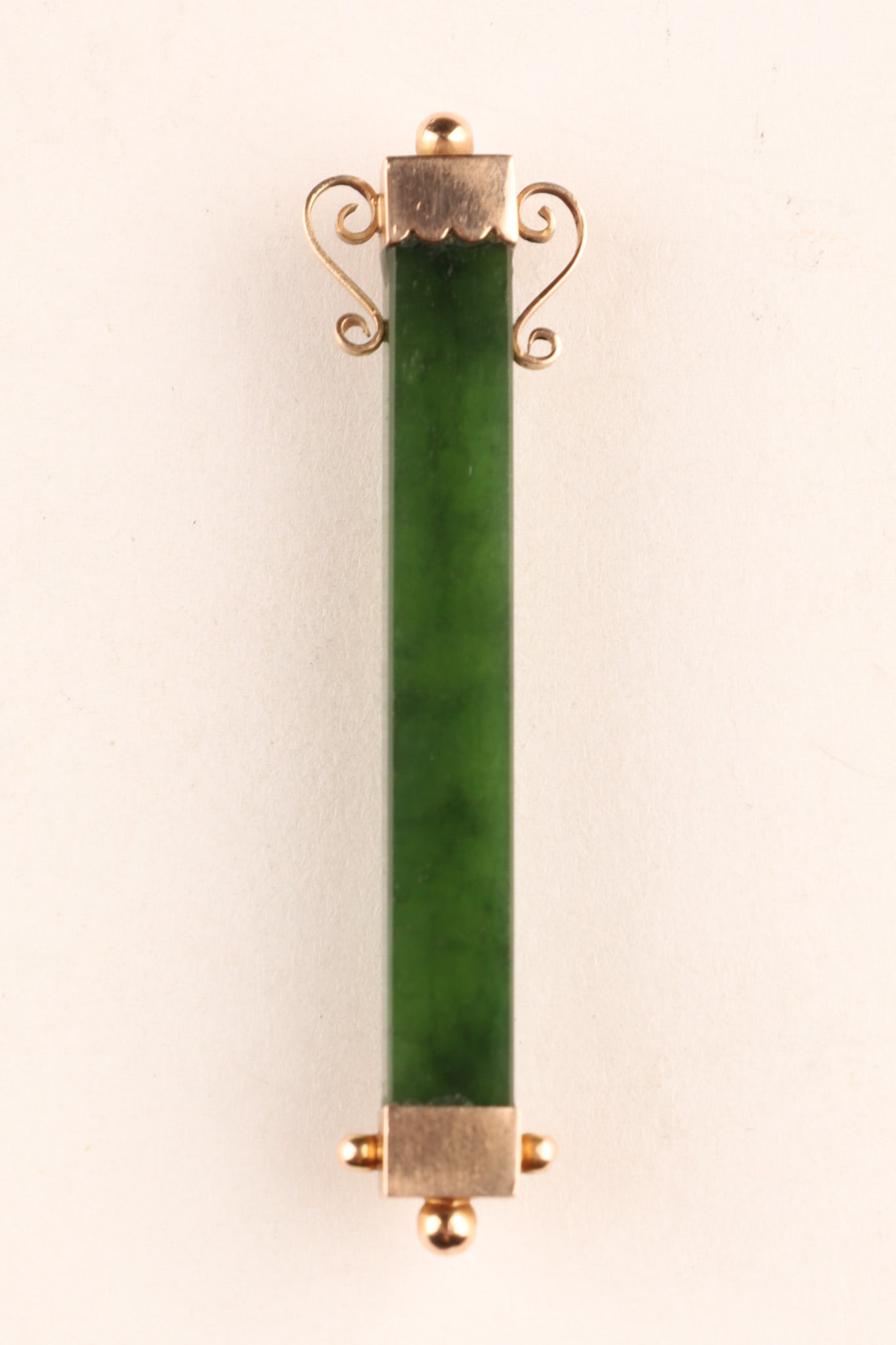 Victorian 9K Gold Seaweed Green Jade Bar Pin: An elegant Victorian-era bar brooch featuring a long, polished bar of deep green seaweed jade. The bar is securely capped at both ends with 9K yellow gold findings, beautifully accented with delicate 