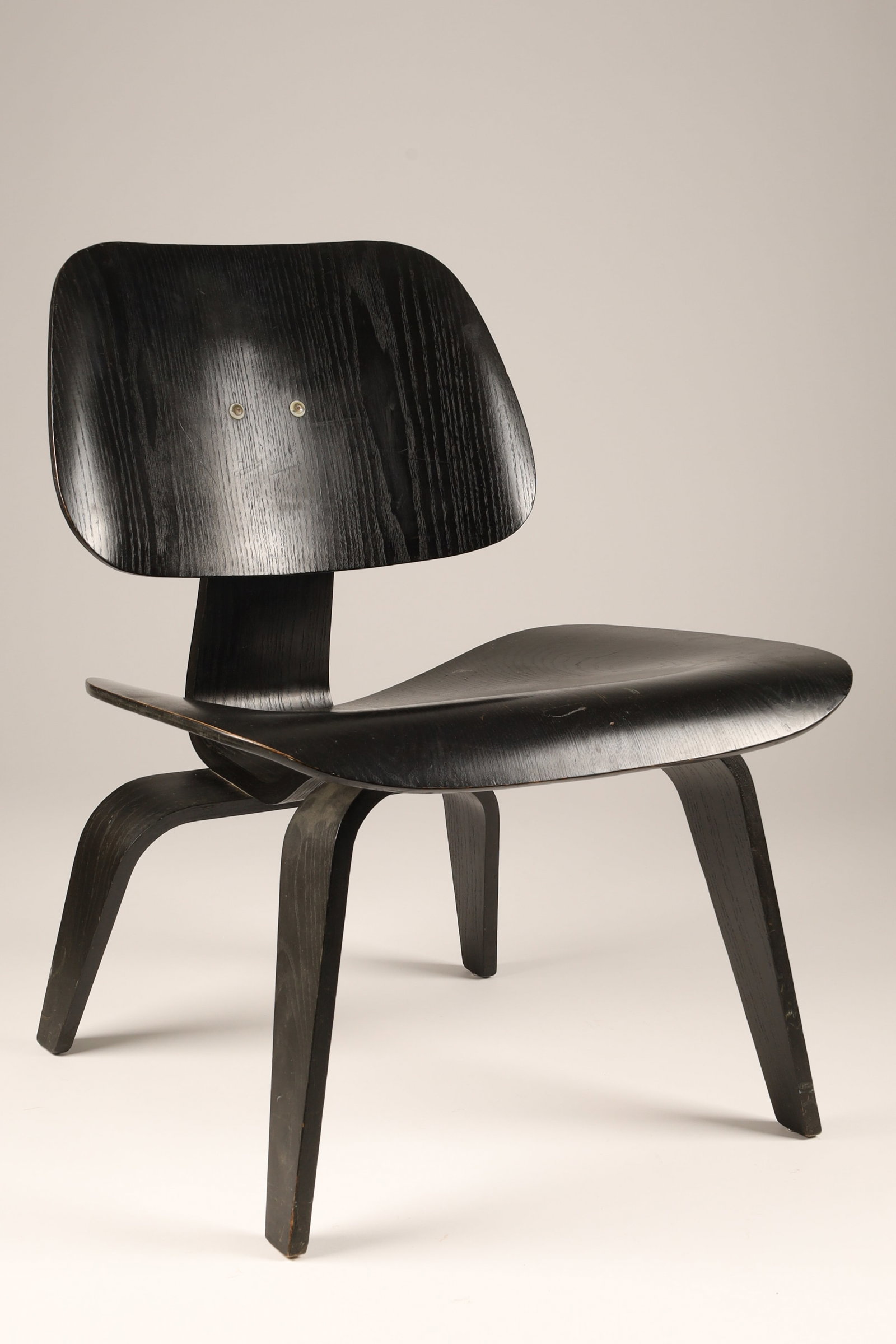 1960s Herman Miller / Eames Black LCW Lounge Chair: A vintage 1960s Eames LCW (Lounge Chair Wood) produced by Herman Miller, featuring a factory-original black aniline stain or ebonized finish. Designed by iconic mid-century modern visionaries Charles 