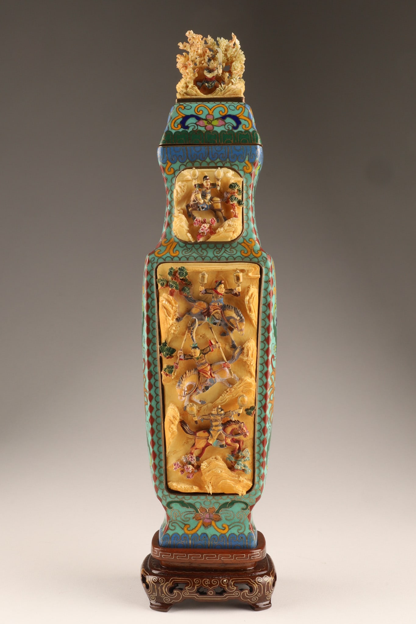 Chinese Cloisonne Urn Inset Hand Carved Bone Panels Warriors: Chinese cloisonne covered urn of a rectangular form, the sides inset with carved bone panels showing warriors and riders on horseback with hand tinted details, a complimentary design on inset on the t