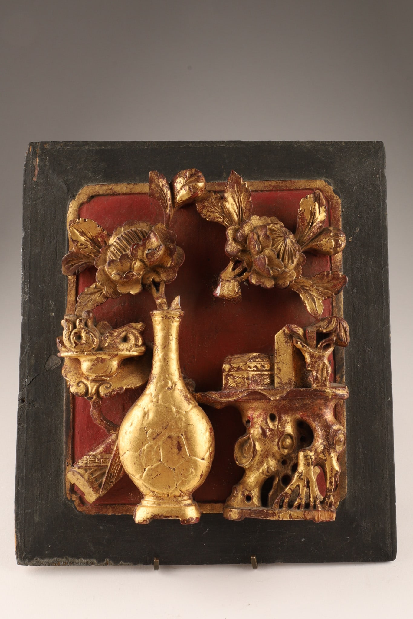 Antique Chinese Giltwood Decorative Carved Panel: A 19th C. Chinese Qing Dynasty carved wood panel. Features high-relief giltwood floral vase motif on red lacquer. Measures approximately 10x9 inches. Loss noted to one of the branches emanating from t