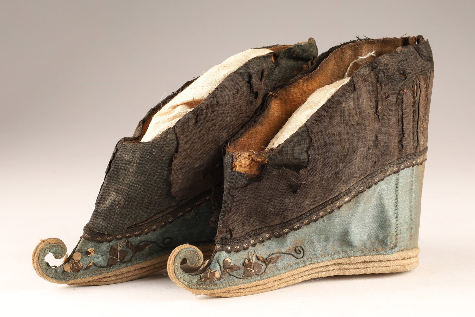 Antique Chinese Silk Lotus Shoes for Bound Feet, Late Qing Dynasty: A pair of antique Chinese lotus shoes dating from the late Qing Dynasty (19th century), handcrafted for women with bound feet, these shoes feature the classic, severely tapered pointed silhouette. The