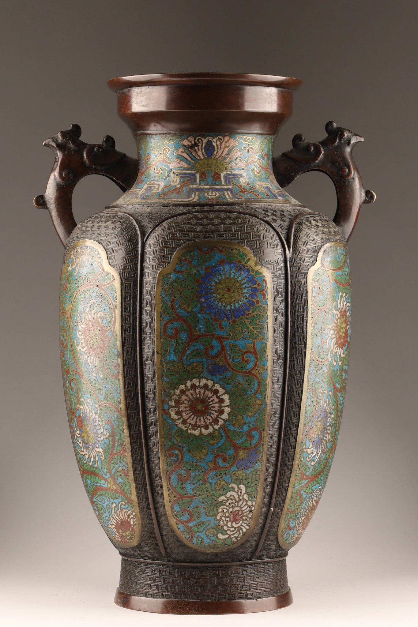 Antique Japanese Meiji Champleve Enamel Bronze Vase with Bird Handles: Japanese Meiji period (1868-1912) bronze vase featuring enameled champleve decoration with distinctive bird handles. The surface displays intricate floral patterns of chrysanthemums and geometric moti