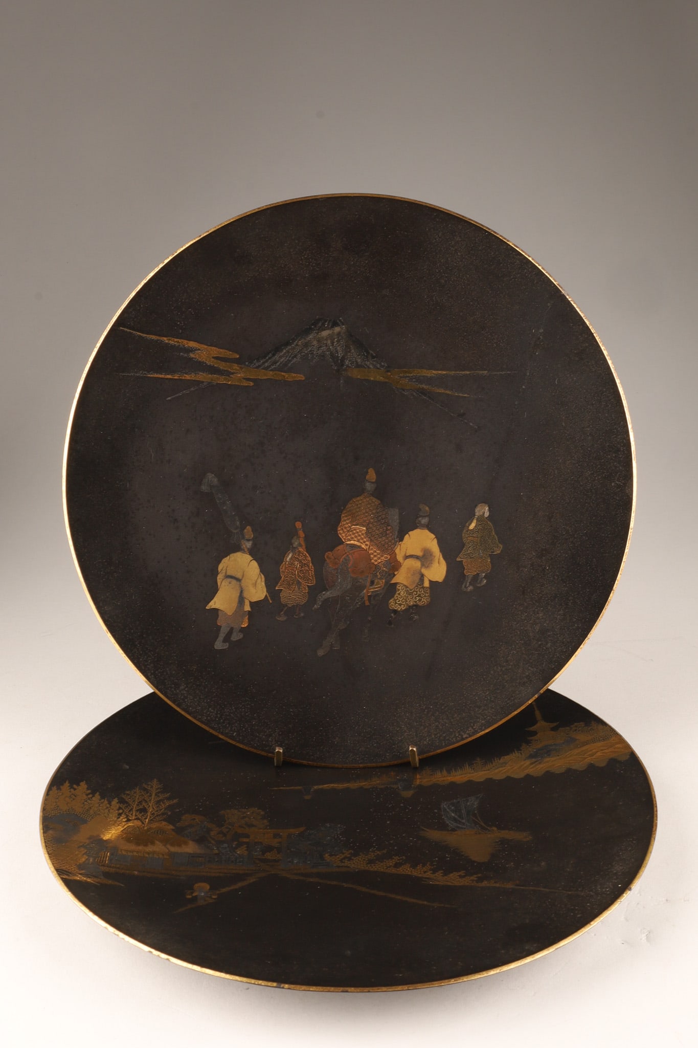 Pair of Japanese Meiji Period Mixed Metal Damascene Dishes, Signed: A pair of Japanese iron damascene cabinet dishes dating from the Meiji Period (1868-1912), each dish features intricate gold and silver wire hammered onto a matte, black-patinated iron ground. Both fe