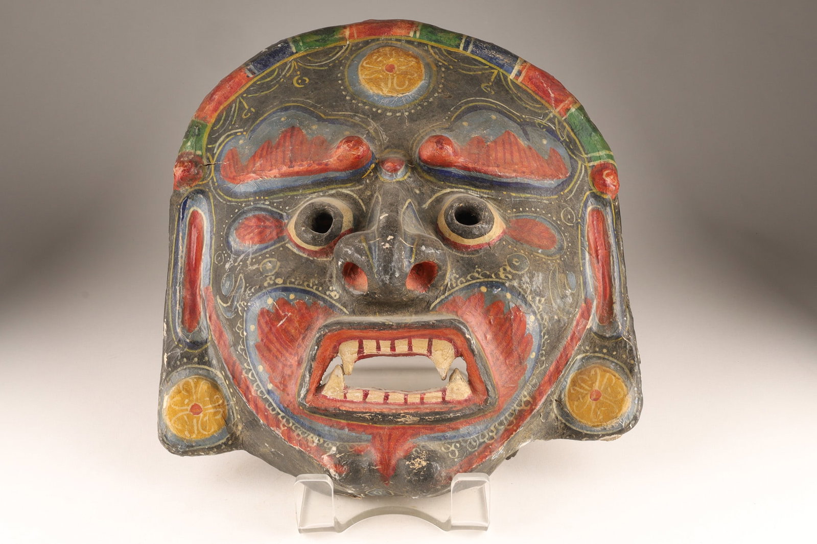 Nepalese Tibetan Bhairav / Lord Shiva Ritual Dance Mask: Nepalese Bhairav mask made of plaster and papier-mache, hand-painted in red, blue, and gold paint, and features prominent teeth and a fierce expression. This mask represents Bhairava, a fierce manifes