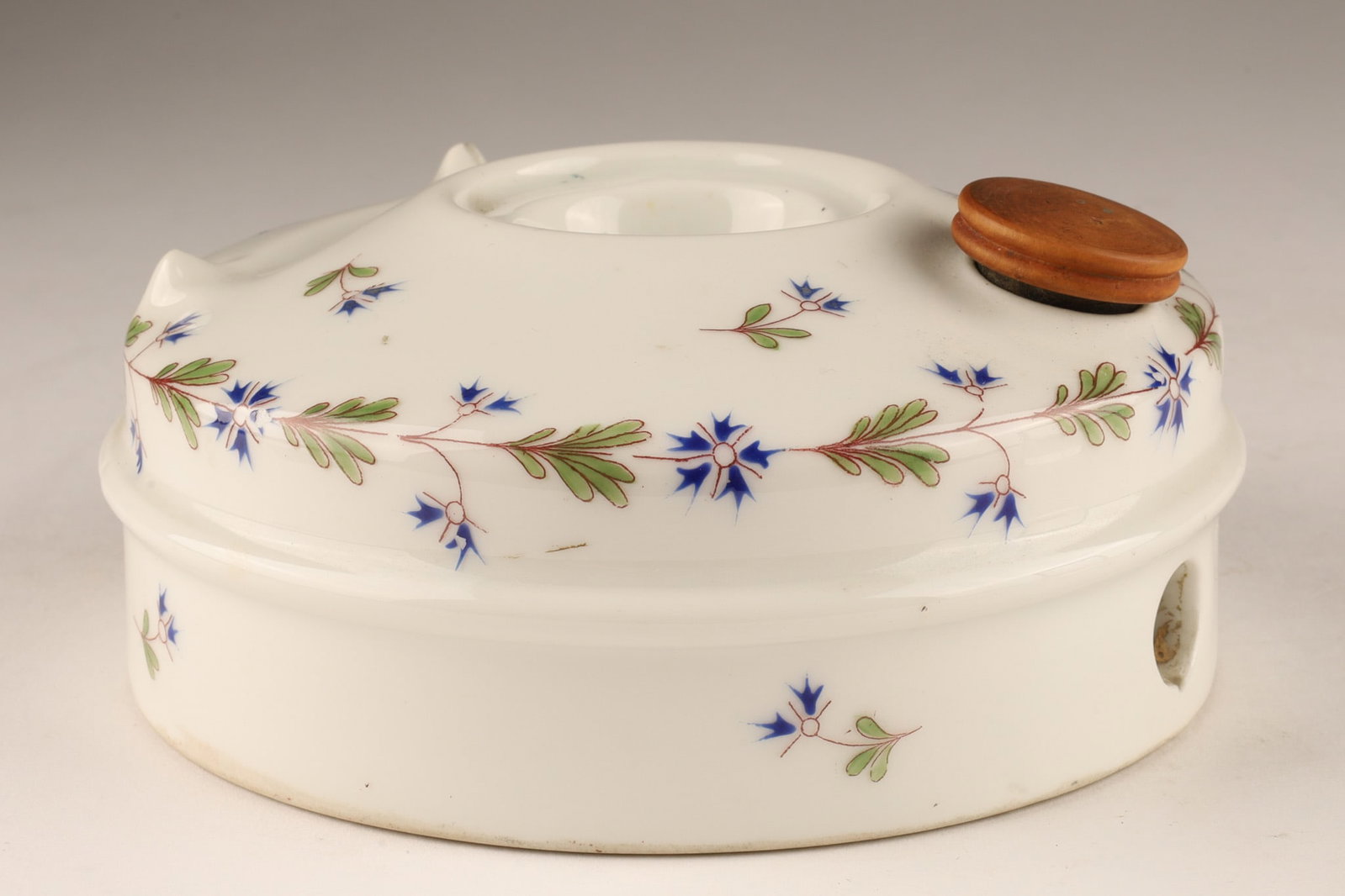 Antique French Porcelain Inkwell Le Plenum: An antique French porcelain inkwell known as Le Plenum, featuring a delicate barbeaux (cornflower) floral pattern and a built-in tray to hold a dip pen or quill. Measuring 5 inches W x 2 H.