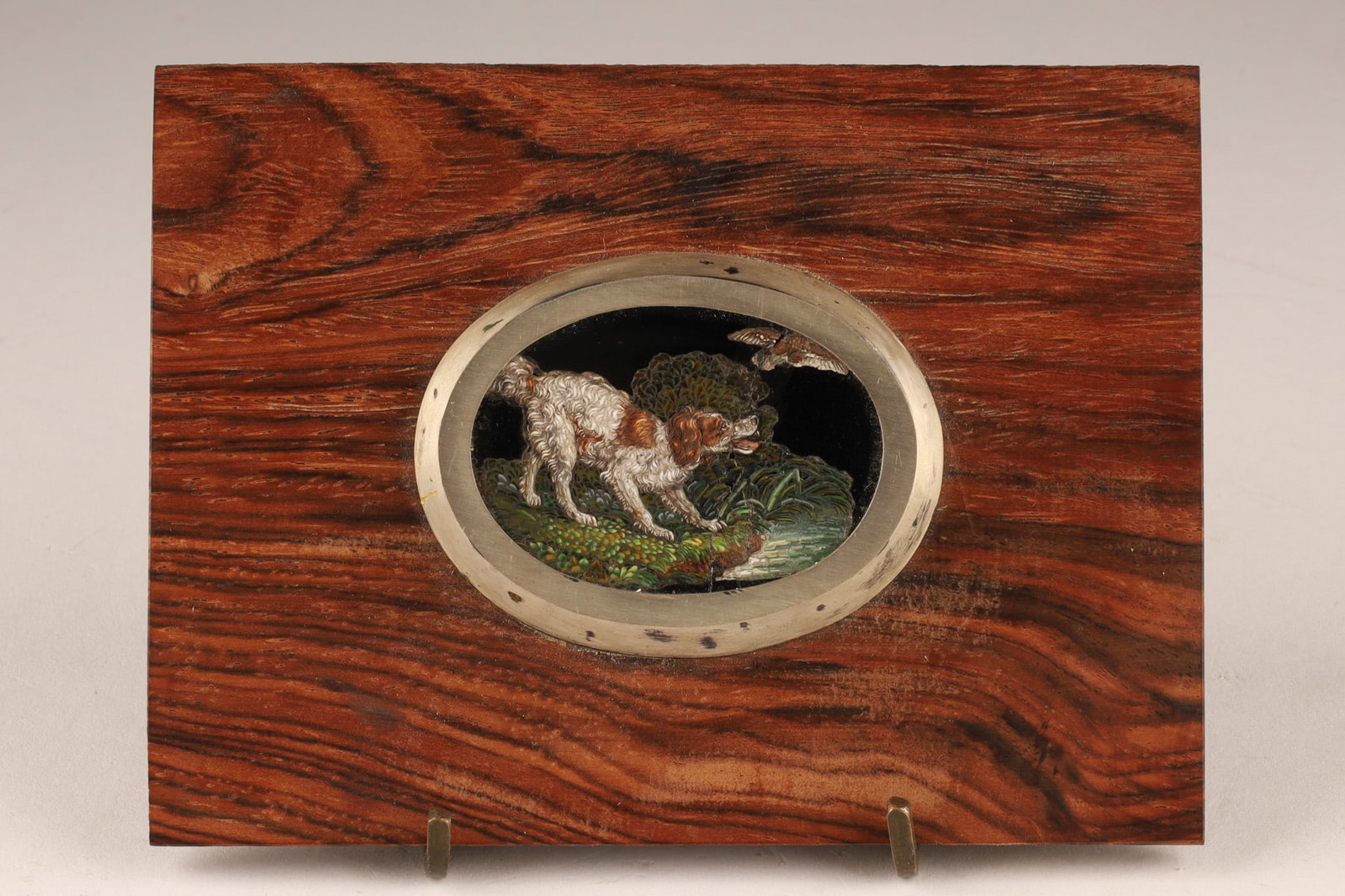 Antique Italian Grand Tour Micromosaic Plaque Hunting Dog Landscape Scene: An antique 19th C Italian Grand Tour micromosaic decorative plaque features a detailed dog scene set within a metallic frame on a polished wood plaque. Scene measures 1.75 inches W x 1.25. Plaque has 