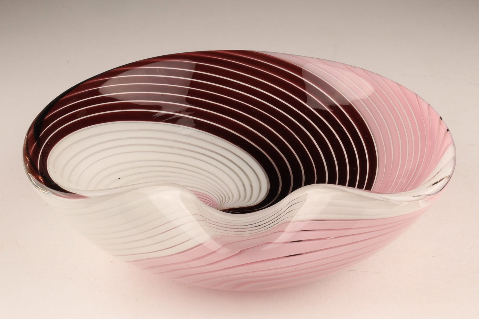 Dino Martens for Aureliano Toso Murano Italy Filigrana’ Bowl c.1950s: A 1950s Mezza Filigrana pinwheel freeform bowl designed by prominent Italian painter and designer Dino Martens for the renowned vetreria Aureliano Toso in Murano, Italy. Measuring 7 inches W x 2 H. Un