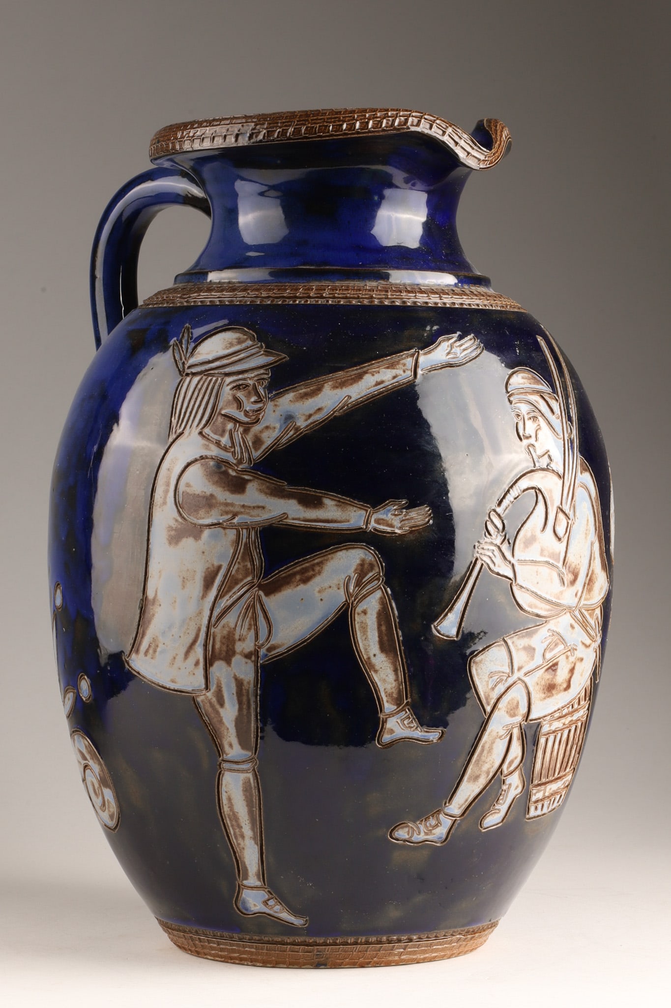Art Deco Roger Guerin Glazed Stoneware Pitcher Jug, Ca. 1930: An Art Deco salt-glazed stoneware pitcher jug by noted Belgian ceramicist Roger Guerin (1896-1954), produced in Bouffioulx, Belgium, circa 1930. The ewer-form body features a rich cobalt blue glossy g