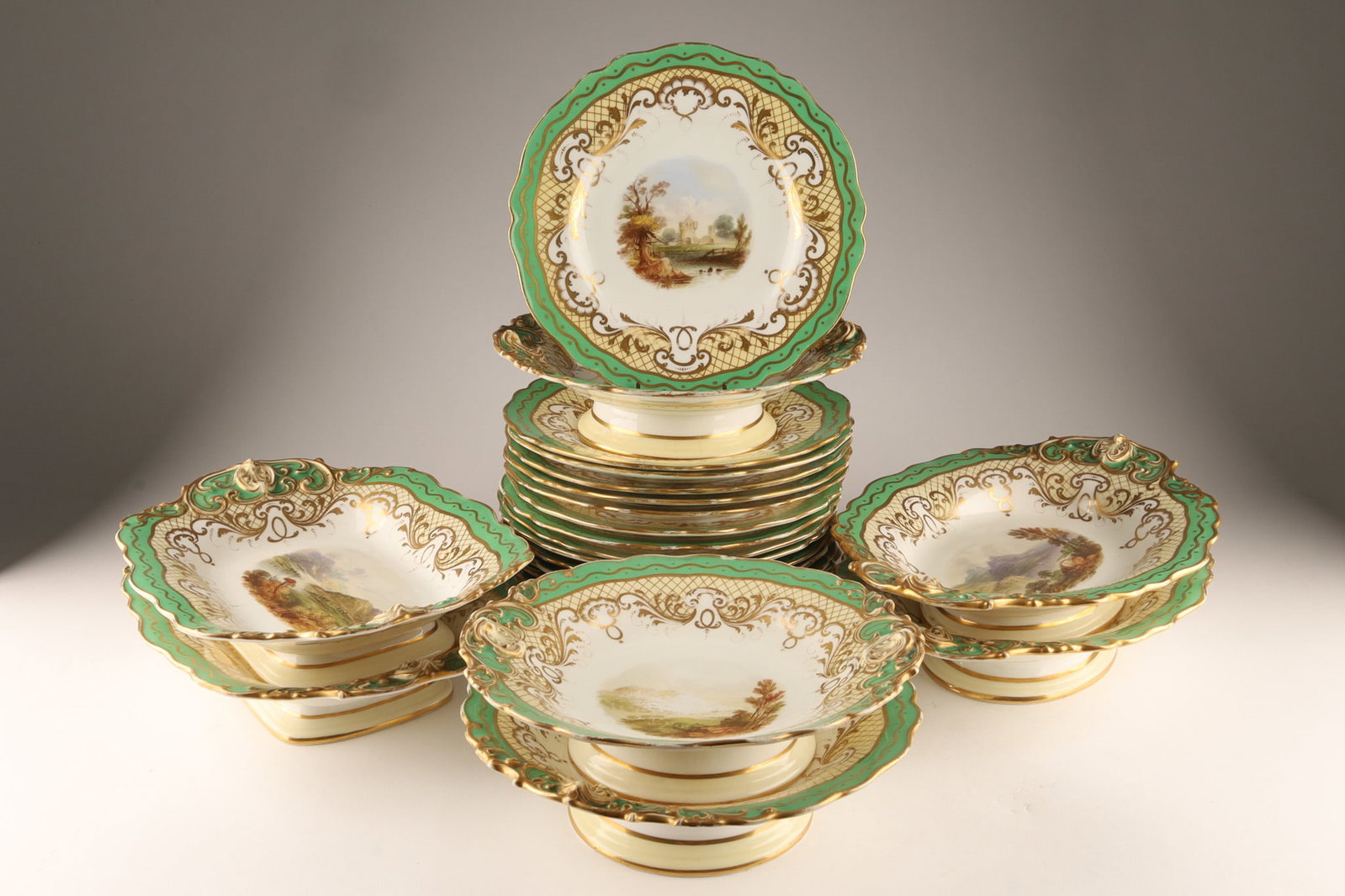 Mid-19th Century Copeland Porcelain Part Dessert Service (Pattern 8966): A fine English bone china partial dessert service by W.T. Copeland (Staffordshire, England, circa 1850). The set features an apple-green border overlaid with elaborate, bright Rococo revival scroll gi