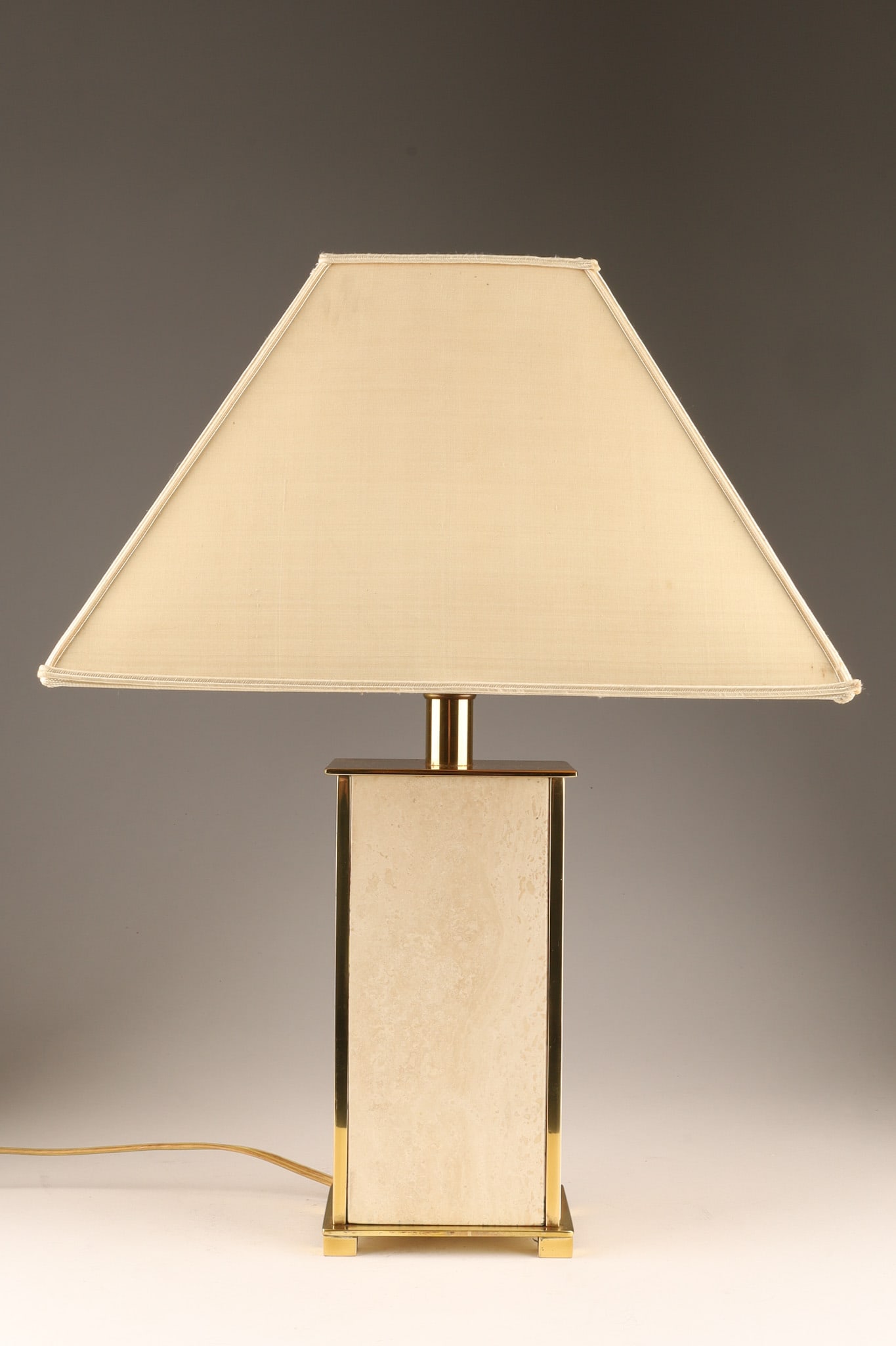 1970s Travertine and Brass Table Lamp / Att. Camille Breesch: A vintage French table lamp features a travertine base with brass accents and a silk shade, dating from the 1970s attributed to or style of Camille Breesch. Measuring 18 inches H x 13 W x 9 deep.