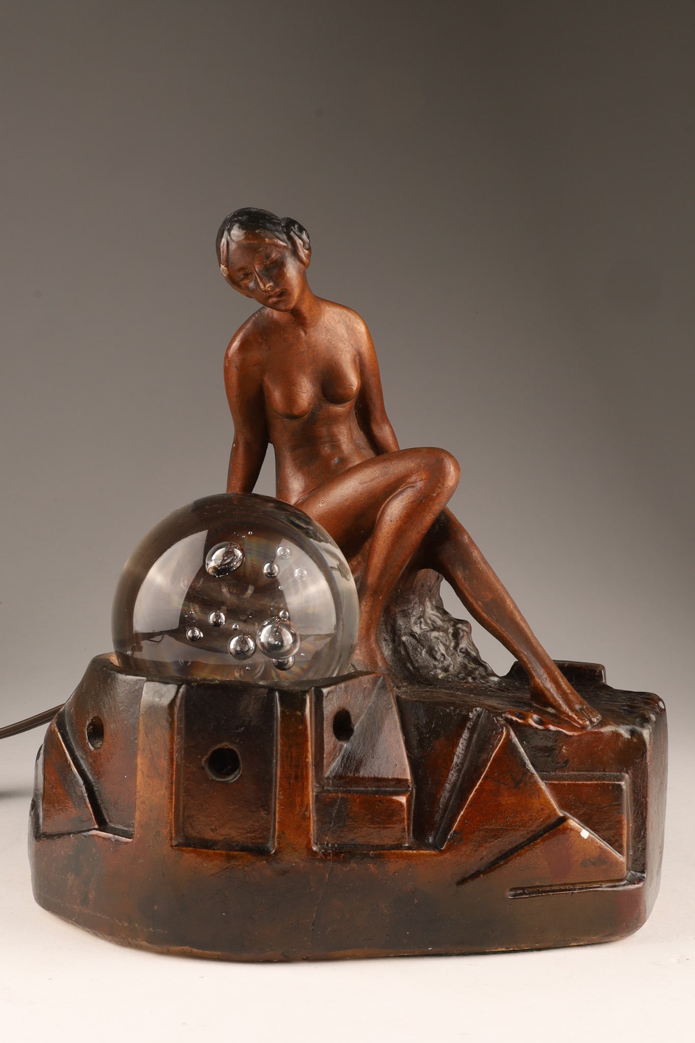 1930s Art Deco Chalkware Nude Lady Florentine Lamp: Art Deco 1930s Vintage Nude Lady Lamp featuring a seated female nude leaning over a glass orb lit from below. Old label on reverse marked Florentine Lamps. Measuring 10 inches H x 8 W x 7 deep.