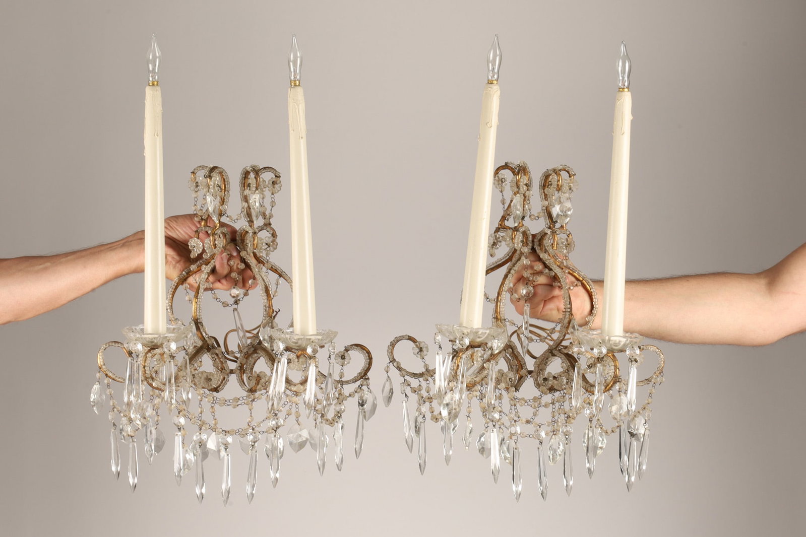 Antique French Crystal Beaded Bronze Wall Sconces Electrified: Pair of antique French or Italian 2-branch bronze wall sconces, the frame attached with beaded crystal and hanging facet cut prisms, originally would have been for candles but they have been electrifi