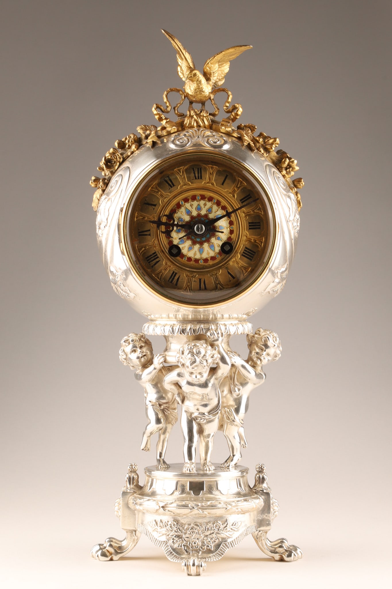 19th C Antique Silver Plated Japy Freres Cherubs Mantel Clock: 19th C Antique Silver Plated Japy Freres Cherubs Mantel Clock featuring a large, finely detailed gilded spread-wing bird landing on an ornate floral garland with a circular clock face decorated with r