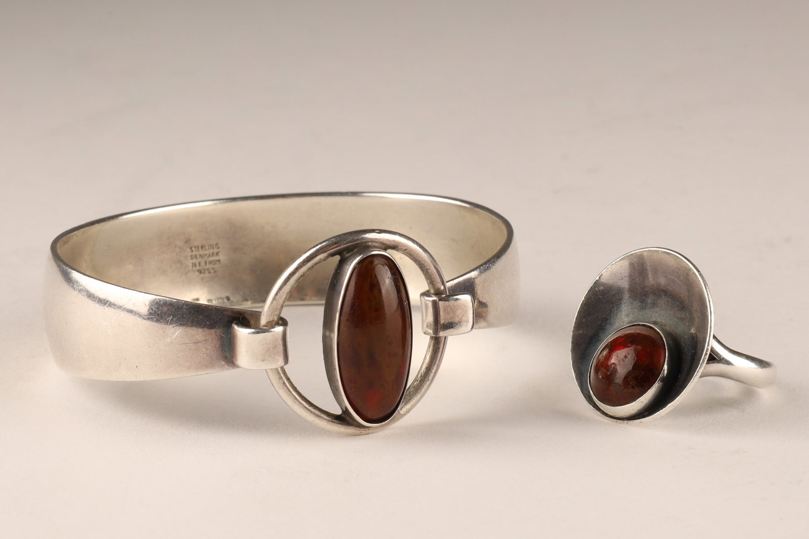 Niels Erik From Denmark MCM Ring and Bangle Bracelet, Sterling and Amber: A lot of one bangle bracelet and one ring, signed NE 925 for Niels Erik From. They feature amber cabochons. The bangle is 7.25 inches in outer diameter and the ring is a size 6. Total weight of 33.8 g