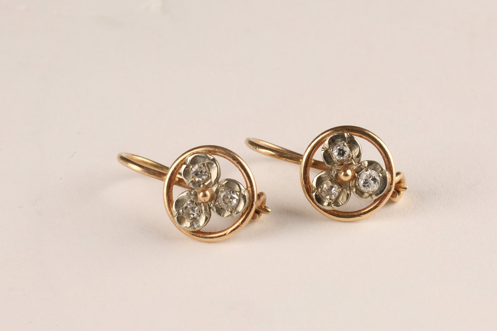 Antique 14K Gold and Diamond Trefoil Earrings: Antique Trefoil Earrings, made of 14kt rose and white gold, set with 5 antique round diamonds (2.1mm) and 1 later diamond synthetic replacement of 2.1mm. Tested to be 14kt. 2.9 grams total, approx. 1 