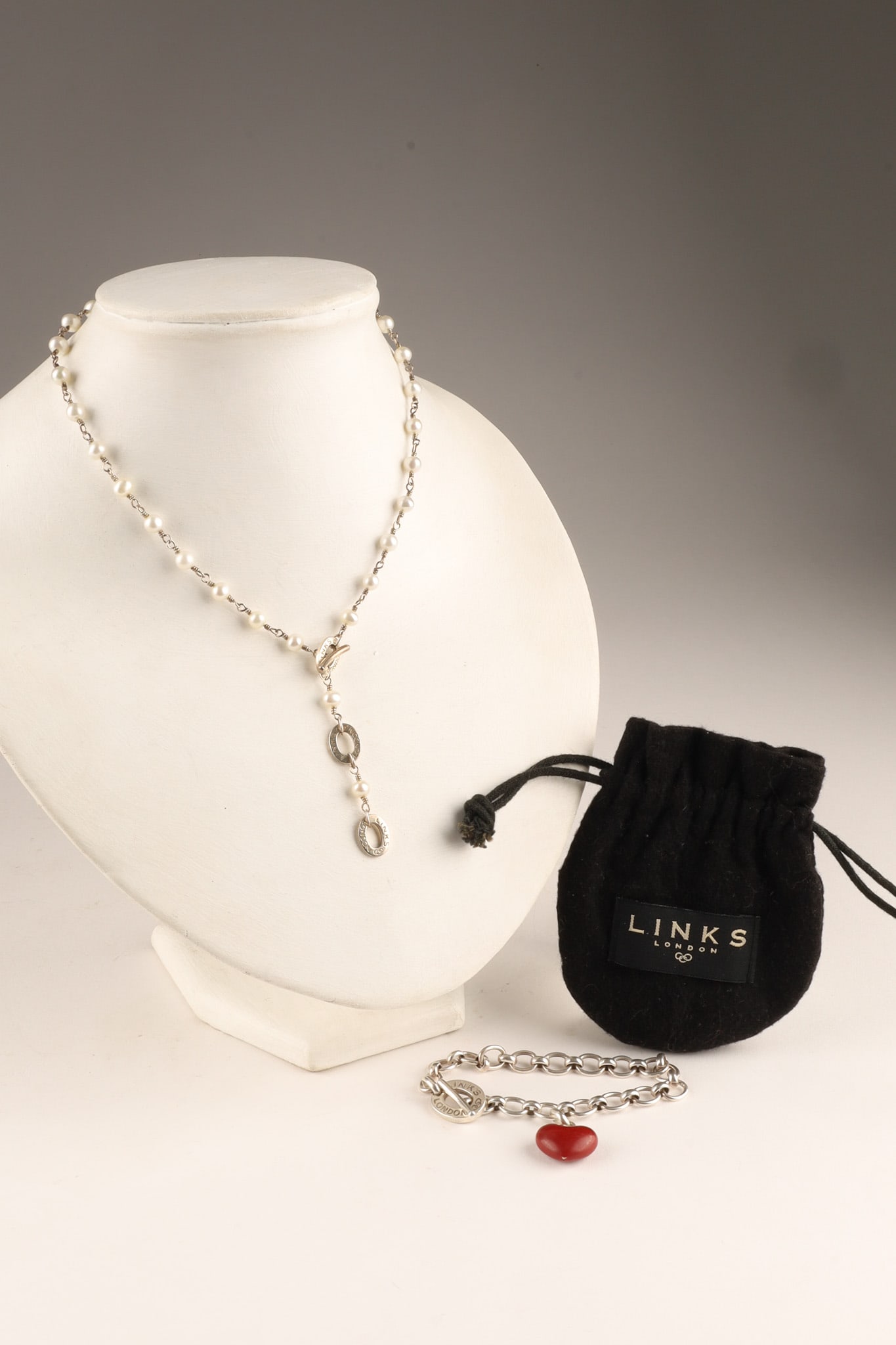 Links of London Sterling Silver Pearl Y-Necklace and Enamel Heart Bracelet: Two-piece lot of sterling silver jewelry set by the British designer Links of London. Both pieces feature toggle closures. Pearl Y-Necklace: A lariat-style drop necklace featuring 5mm freshwater pearl