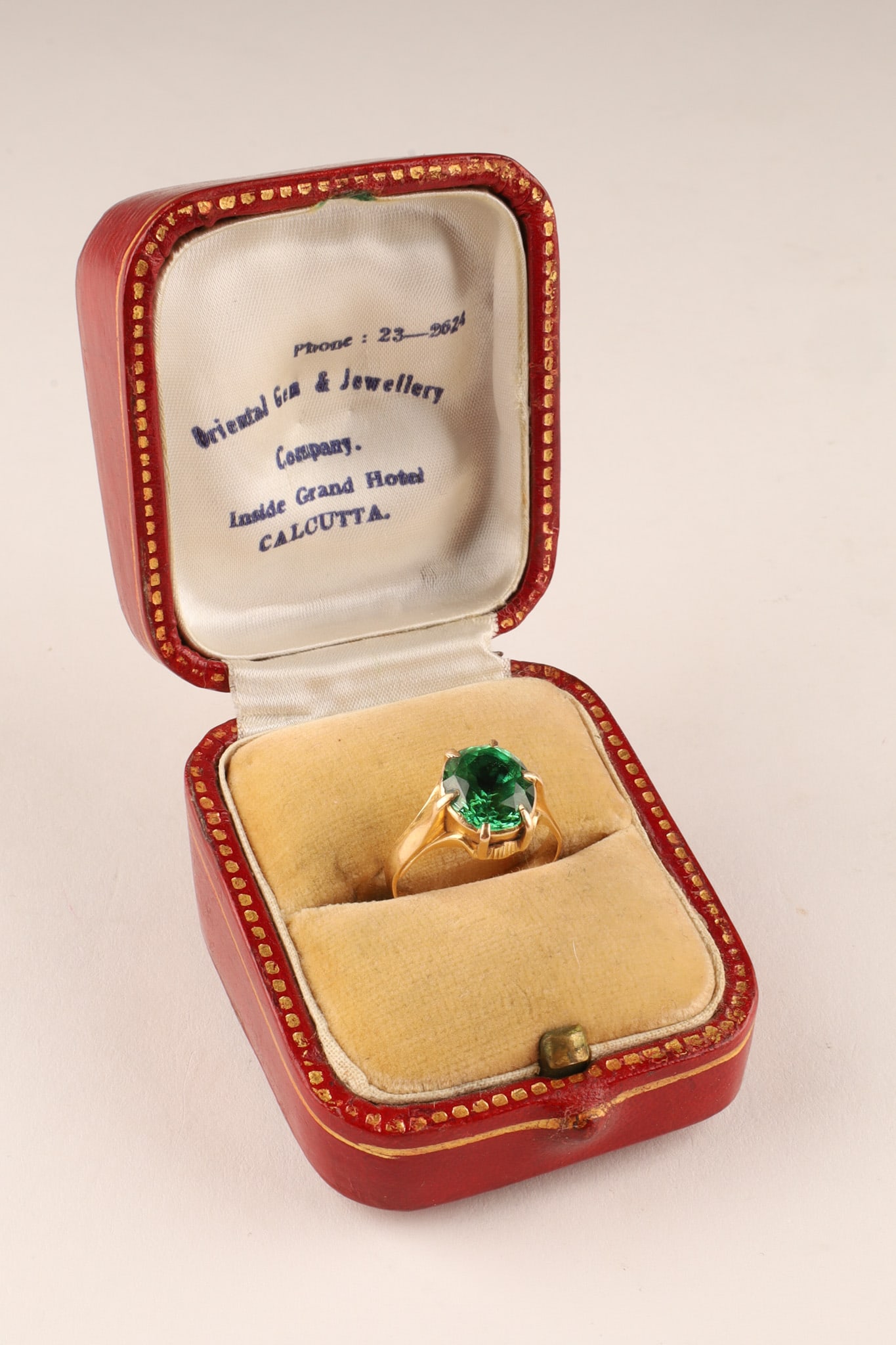 18K Yellow Gold Ring with Green Topaz in Old Leather Ring Box, size 6: An Antique 18K Yellow Gold and Green Topaz Solitaire Ring, Accompanied by a Historic Calcutta Retailer Box. A classic antique solitaire ring crafted in solid 18K yellow gold, securely prong-setting a 